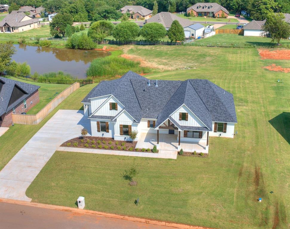 Welcome to your dream home—a stunning modern farmhouse nestled on a picturesque .92 acre overlooking a peaceful pond. This beautifully crafted residence blends rustic charm with contemporary elegance, offering the perfect escape from the everyday hustle.

Step inside to discover an open-concept layout flooded with natural light, featuring vaulted ceilings, exposed beam, and wide-plank woodlook floors. The gourmet kitchen boasts quartz countertops, a farmhouse sink, open shelves, Zline range, and stainless steel appliances—ideal for entertaining or cozy family dinners. Want a butler's pantry? You got it! And this one is so cute!

The spacious primary suite offers a private entrance to the back patio w/ pond views, a spa-inspired bathroom with a soaking tub, large shower, and dual vanities. Additional bedrooms are generously sized, and an upstairs bonus space adds versatility.

Outside, enjoy morning coffee on the porch, host gatherings on the expansive front porch w/ space for al fresco dining, or unwind by the water’s edge w/ your fishing pole. The acre of land provides ample space for gardening, play, and your creativity—your private slice of countryside just minutes from town.

? Highlights:

4-5 Bedrooms | 3.5 Bathrooms

Open-concept living with designer finishes

Pond-front views and outdoor living spaces

Almost an acre of land with a fully fenced portion

Attached garage and modern amenities throughout

This one-of-a-kind property offers the perfect blend of luxury and nature. Schedule your private tour today and experience the magic for yourself!