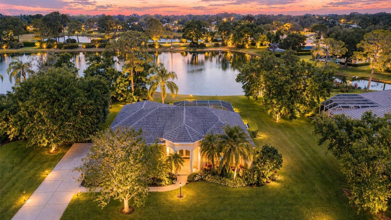Tucked away at the end of a quiet cul-de-sac, across from dedicated preserve land and within the gates of The Preserve at Misty Creek, 8311 Flagstaff Way offers a rare blend of relaxed Florida living and near proximity to all Sarasota has to offer. Set on nearly half an acre of beautifully landscaped, lakefront property, this residence feels like a retreat—where mornings begin with tranquil water views and evenings unfold under the soft glow of your own outdoor fire pit. Spanning nearly 2,900 square feet, this single-story home has been carefully improved and maintained over the years, creating a move-in-ready experience with both style and substance. Inside, volume ceilings, crown molding, and an abundance of natural light create a warm and open atmosphere. The kitchen and family room flow seamlessly together, anchored by a fully remodeled kitchen featuring solid wood cabinetry, stone counters, updated lighting, and stainless-steel appliances including a wine refrigerator. The home has seen extensive interior enhancements, including updated flooring, bedroom carpeting, interior painting, and refined finishes throughout. Both the kitchen and bathrooms have been tastefully remodeled, increasing the value of the home. Major systems and functional upgrades provide peace of mind. The property features NEW TILE ROOF 2024, two newer air conditioning systems, updated electronic heat assembly, and a variety of mechanical improvements that reflect careful ownership. Additional updates include refrigerator, garbage disposal, washing machine and dishwasher, along with improvements to lighting both within the home as well as outdoors. Hurricane resistant PGT windows ensure peace of mind.Step outside and the lifestyle truly comes to life. The screened, heated pool and spa overlook the lake, framed by updated and sealed pool pavers and a refreshed enclosure. A newer pool heater, motor, and actuator ensure everything operates seamlessly. The outdoor living space has been expanded with a custom patio and fire pit area for entertaining or simply unwinding. The grounds have been thoughtfully maintained and enhanced, including irrigation system updates and landscape improvements, to maximize both usability and aesthetics. Additional exterior improvements include garage upgrades with new door components and opener. Located in an X flood zone and built with solid block construction, the home combines durability with comfort. The side-entry garage includes a workshop space, adding functionality for hobbies or storage. Living in Misty Creek means enjoying a 24-hour guard-gated community with LOW HOA fees, SPACIOUS LOTS, and OPTIONAL golf membership. Sidewalk-lined streets for walking and cycling, a peaceful animal preserve setting, and access to fishing and bird watching create a lifestyle that is simultaneously active and serene. Luxury of top-rated schools, including The Classical Academy, are nearby.  With just a short drive to the pearlized quartz sand of Siesta Key Beach, a multitude of dining options, and cultural amenities including theater, galleries, ballet, opera, circus and live music, this home offers the perfect balance of privacy and convenience. 8311 Flagstaff Way is more than just a home—it’s a property that has been continually improved, carefully cared for, and thoughtfully elevated to offer its next owner a truly effortless Florida lifestyle. Listing agent resides in this phenomenal community!