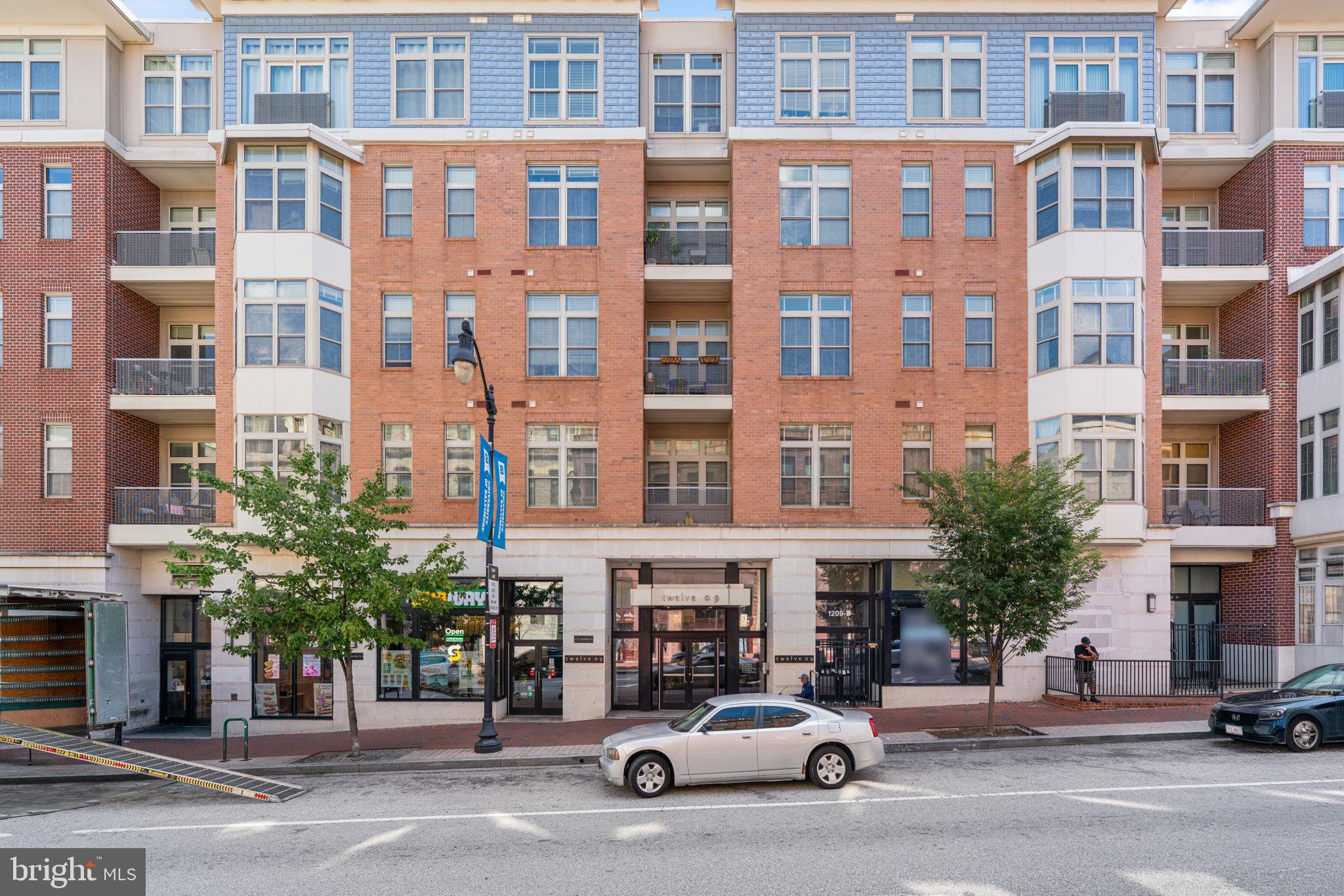 Come see this amazing apartment at 1209 N Charles, a luxury apartment complex in the midtown/mount Vernon area of Baltimore. This elevated unit boasts 2 hug bedrooms each with an ensuite bathroom. The primary bedroom has a zero entry updated shower which is perfect for anyone with mobilty issues, but also great if you don't. A gourmet kitchen with stainless steel applicances opens to an expansive dining and living space. This connects to a lovely balcony. There is a nook perfect for a work from home desk. Washer dryer in unit creates the ultimate convenience. This building includes an elevated entry way with security system, amazon lockers and elevators. The fully equipped fitness center and lovely courtyard make this building a must see. This unit comes with 2 garage parking spaces! This unit has the perfect location for city living. Close to many restaurants and sights like the Baltimore symphony orchestra, Penn station (MARC train and Amtrak), University of Baltimore, The Lyric, Walter Art Museum, Washington Monument, the famous Peabody Library, just to name a few. Make your appointment today before its gone.