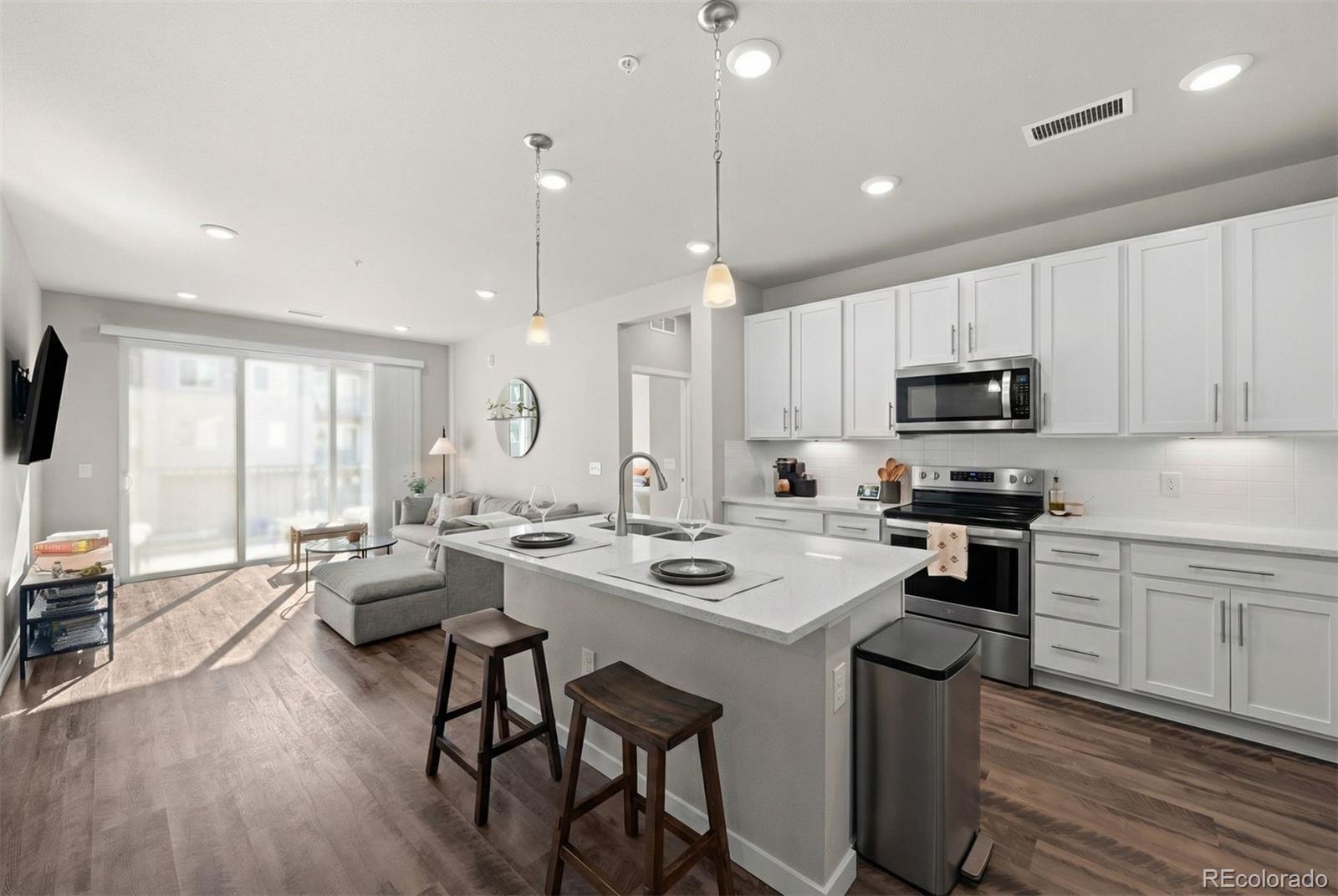 This beautiful 2-bedroom condo in Littleton Village offers the freedom of a low-maintenance lifestyle with thoughtfully updated finishes, excellent parking options, and a light-filled, open design, all in a prime location. The kitchen features a large quartz center island, 42" soft-close white cabinets, and a versatile counter area with added storage, perfectly positioned within an open floorplan that captures abundant natural light throughout. The primary bedroom offers a private ensuite bath and a generous walk-in closet with beautiful closet built-ins. Parking and Storage is effortless with a private and secure single-car garage for a vehicle plus bikes, skis, or whatever fun tools for adventure you may have! Plus two parking passes for the community lot. Access to the unit is simple, with the added convenience of an elevator if preferred. Ideally located for an active Colorado lifestyle, Littleton Village is just minutes from The Streets at Southglenn, the High Line Canal, and Chatfield Reservoir, with seamless access to DTC, Denver, and C-470 for easy commuting and weekend adventures. Healthcare professionals will appreciate Littleton Hospital just blocks away, with CU Health only a short drive from home. Community amenities include a fully equipped fitness room, a rooftop patio with barbecues and a fire pit, as well as access to a nearby park, with a playground and dog park. This thoughtfully designed home delivers everyday comfort, ease, and a lifestyle that adapts to how you live.