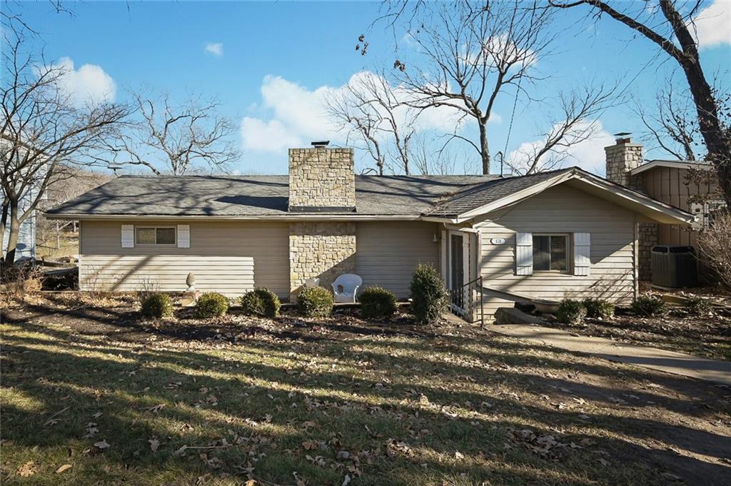 Charming and comfortable, this lakefront home provides a welcoming lake retreat.  Offering a fabulous deep water double well dock as well as a second-tier lot across the street, which is great for guest parking, AND it has a very nice main body lake view. Docking consists of a double-well dock with side swim area, lifts, and an upper sun deck in perfect water.  Lakeside Kitchen is conveniently located for entertaining.  This home has pretty knotty pine accents and a fireplace in the living room.  The enclosed porch just off the primary bedroom provides a cozy spot at any time of the day.  Enjoy lakeside fun at any of the four outdoor entertaining areas, which include two lakeside patios, a deck off the kitchen, and the upper deck of the dock.  You won't want to miss this lake charmer.