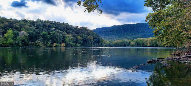 Shenandoah Riverfront HomesteadA rare opportunity to own 16+ acres of premier Shenandoah River frontage, with direct access to the river and Agricultural zoning. The property is currently enrolled in the Land Use Taxation Program, offering the benefits of agricultural land use. Beautiful, level and open acreage provides easy access to both the property and the river, while offering privacy, versatility, and an exceptional setting for a variety of agricultural, equestrian, recreational, and lifestyle uses. It simply doesn't get much better than this property!The property features two separate living quarters. The main residence offers a spacious and versatile floor plan with a living room/den, kitchen and dining area, two sunrooms, mud/laundry room, six bedrooms, and 2½ bathrooms, including one handicap-accessible bath. A fenced yard surrounds the primary residence. The second living space is an Accessory Dwelling Unit above the garage, surrounded by an approximately 6-foot deck and offering beautiful river views. This open loft-style residence features two bedrooms, one bath, open living/dining area, and laundry—ideal for guests, extended family, or additional private living space.For the equestrian enthusiast, the property offers two barns, a feed shed, and approximately 5–6 acres of fenced pasture ready for horses or livestock. A separate metal shop with reinforced concrete flooring includes a 9,000-lb. rotary two-post lift, providing an excellent workspace for equipment, vehicles, farm projects, or hobbies. Two natural feed ponds add to the property's agricultural and recreational appeal.Enjoy easy access to the Shenandoah River for kayaking, canoeing, fishing, camping, and other outdoor activities. With its combination of open pasture, river frontage, barns, ponds, multiple living spaces, and agricultural zoning, the possibilities are extensive. Potential uses include farming, crop production, forestry, livestock, equestrian activities, nursery operations, winery, and other agricultural uses, subject to applicable county regulations and approvals.A truly rare opportunity to create your own Shenandoah Riverfront Homestead.This parcel has an existing thirty foot access easement for 0 Sagar Drive, VAWR2015442 . This property is also for sale.