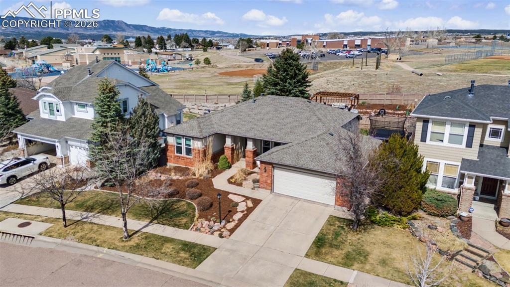Located in the highly sought-after Pine Creek neighborhood & Academy District 20, this beautifully updated home offers a fantastic floor plan, thoughtful upgrades, & a backyard designed for both relaxation & play. Backing directly to the playfields of D20's Mountain View Elementary and Challenger Middle Schools, the home provides a rare level of convenience for school access while also offering open space & privacy. The main level features a highly desirable layout w/ 3 bedrooms on the main, including a spacious primary suite. Recently refinished light-toned hardwood floors create a bright, modern feel throughout the main level. The kitchen has been tastefully remodeled w/ beautiful marble countertops & an incredible walk-in pantry offering exceptional storage & organization. A thoughtful renovation relocated the laundry to the primary closet, creating a convenient main-level laundry space. The finished basement offers exceptional additional living space & a feature that makes this home truly memorable: a custom slide leading from the main level to the basement is sure to delight kids & guests alike. The lower level includes a spacious rec room, exercise room, two additional bedrooms, full bathroom, massive storage room, & a dedicated basement laundry room for added convenience. The meticulously landscaped backyard is fully fenced and features raised garden beds and gorgeous tiered landscaping with large patio and gazebo, creating a peaceful outdoor retreat. An ample storage shed provides additional space for tools & equipment. Recent exterior improvements include freshly painted stucco (Dec 2025), a brand new roof (Dec 2025), & newer main-level windows (2022), offering both beauty & peace of mind. Lovingly maintained & thoughtfully updated by its current owners, this Pine Creek home combines functionality, charm, & location in one of Colorado Springs’ most desirable communities. Schedule your showing today & experience everything this exceptional home has to offer.