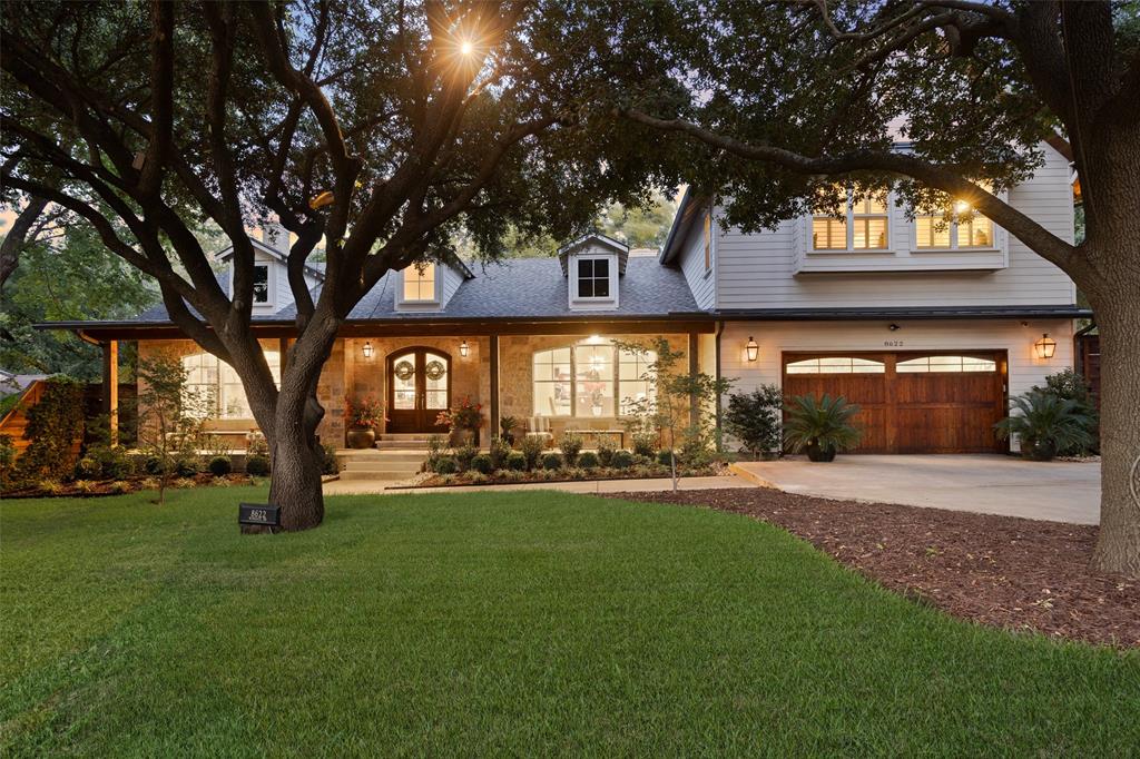 Set on nearly half an acre beneath a canopy of mature trees, this transitional masterpiece blends timeless design with modern livability. Thoughtfully designed with premium finishes and an open-concept layout, the home features a gourmet kitchen and expansive family room with soaring cathedral ceilings and panoramic views of the wooded lot. Outdoor living shines with a spacious deck and outdoor fireplace, perfect for relaxing or entertaining under the trees. The flexible floor plan includes a first-floor owner’s suite, guest bedroom, executive office, and formal dining room. Upstairs offers a third living area, treetop balcony, bonus room, and four additional bedrooms, making it ideal for multi-generational living or hosting with ease. Perfectly positioned near premier dining, boutique shopping, and Love Field airport. A true sanctuary, this home blends luxury, space, and serenity like no other.