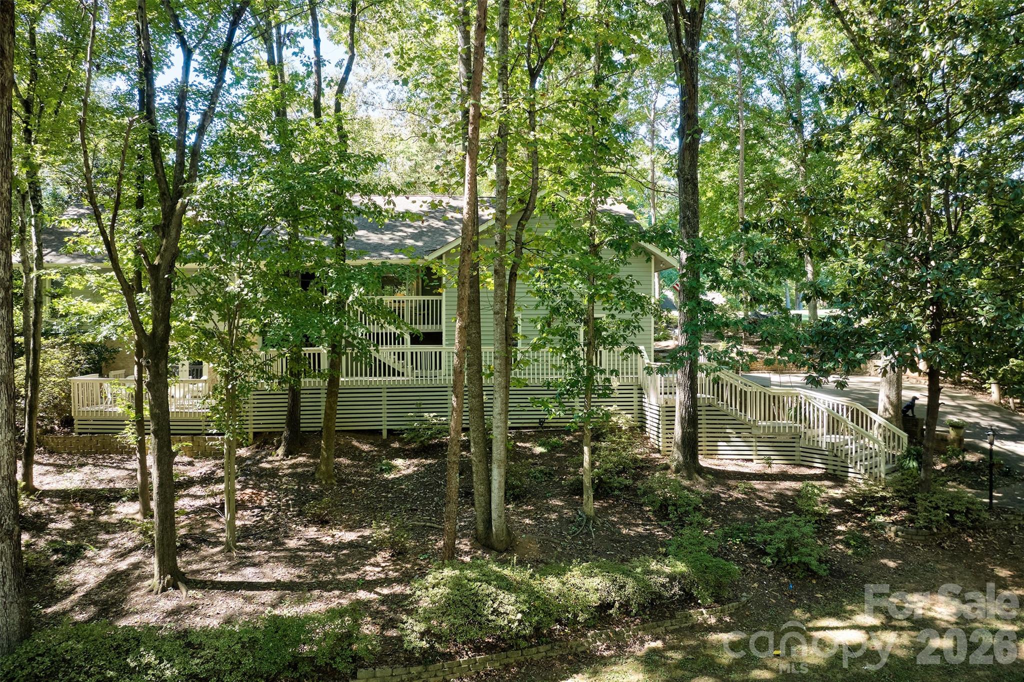 Welcome to the the lake life!  This home is in the gated waterfront and golf community of River Hills just over the SC border.  The neighborhood offers miles of walking trails, waterfront park with sandy beach and picnic pavilion, gardens, dog park, playgrounds, marina with gas dock, country club with championship 18 hole course, clubhouse, 2 pools & restaurant and 24 /7 security.  70  Honeysuckle Woods is located on the 3rd tee box of the golf course and conveniently located close to the front entrance.  Low maintenance yard with irrigation and lots of plants blooming all year round !  The main level offers the oversized primary bedroom, large walk in closet and nice ensuite bathroom, great room with fireplace and built ins, dining room, kitchen with eat in bar and breakfast area, laundry and 1/2 bath.  The lower level would be great for multigenerational living with its own deck and entrance, new wet bar that is entire wall, office area, 2 bedrooms and full bath with walk in shower and large additional living space/billard area/bonus/playroom .  You decide how to use it best!  Don't miss the wine cellar area/storage that connects to the garage from the lower level and the huge storage area under the stairs.  This home does not lack for storage!  There are many areas to enjoy the outside from the front porch, lower level deck and the expansive deck on the back of the house.  Take a deep breath when you come through the gate!  Please call listing agent with any questions about the neighborhood!  www.riverhillsassoc.com