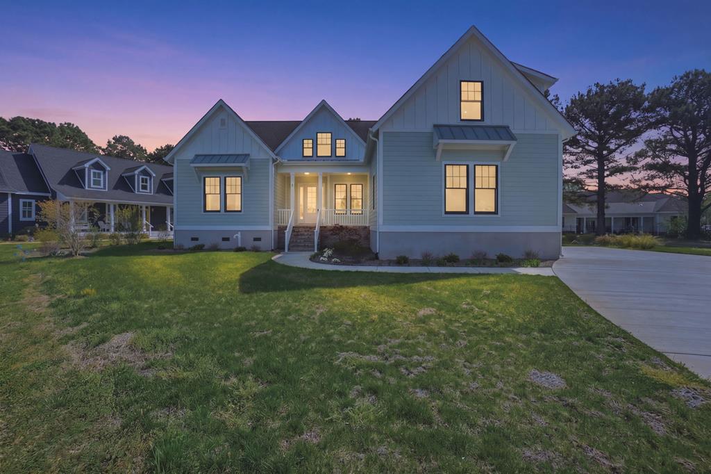 Welcome to this stunning new construction home in Bay Creek's Signature Village! This beautifully designed 5-bedroom, 4.5-bath coastal craftsman is perfectly situated on a quiet cul-de-sac. Built in 2025, this home features a bright and open floor plan ideal for both everyday living and entertaining. The main level offers two first-floor bedrooms, a spacious family room with fireplace, a sunny breakfast area, formal dining room, and a convenient first-floor washer and dryer. The gourmet kitchen is equipped with high-end appliances, making it perfect for cooking and hosting. Upstairs, additional bedrooms and flexible living space provide plenty of room for guests and family.  Enjoy outdoor living with a covered porch overlooking a private backyard making it ideal for relaxing or entertain