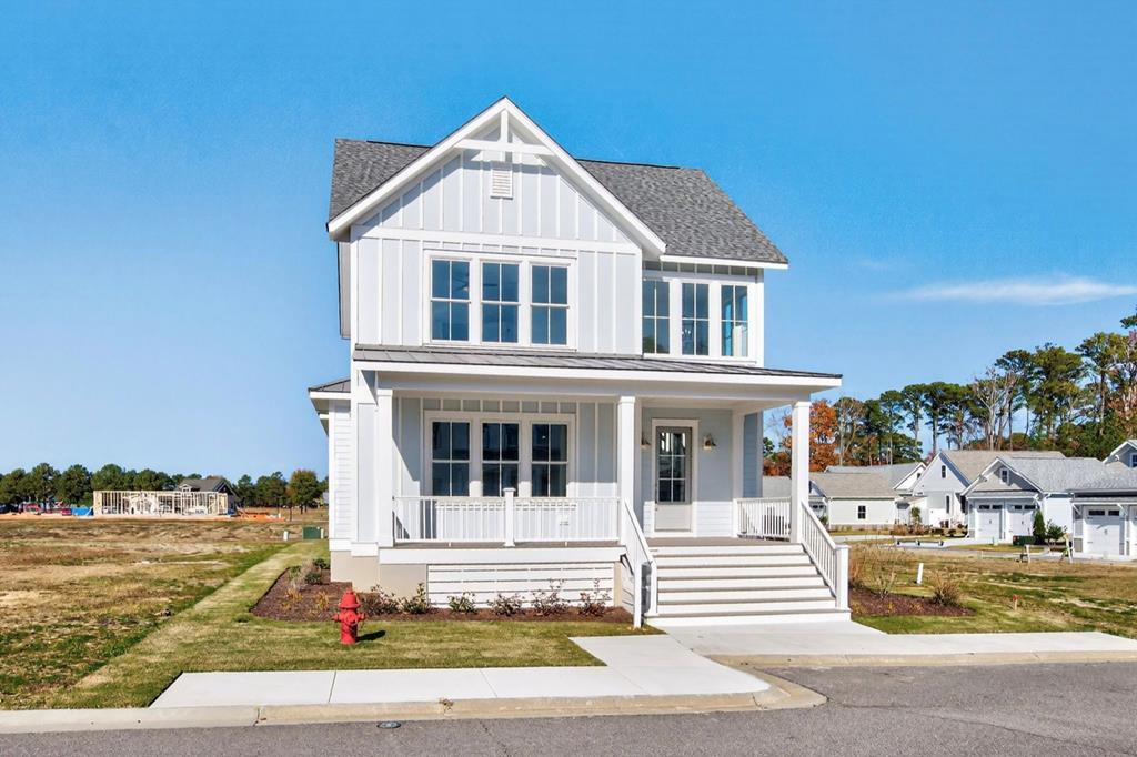 Welcome to The Hampton, one of Preserve Homes and Neighborhoods' most popular plans. Located in the Bayside Village enclave just a short walk to the Life Center and Bay Creek's private beaches. Step through the front door into the two-story foyer, while taking in the spacious family room with fireplace. Adjacent to the family room you'll find the dining area and kitchen, which flows effortlessly onto the private screened-in porch. The main level Owner's Suite offers two walk-in closets and a bathroom with double vanity.  Upstairs are three additional bedrooms, one with its own ensuite bathroom and two sharing a full bath with double vanity. Features include engineered hardwood flooring, 10' ceilings on the main level and KitchenAid appliances.