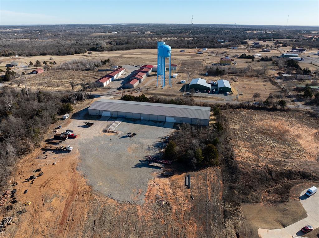 Welcome to Koloa Industrial Park, an exceptional opportunity for your growing business in Edmond, OK. This 24,000 sqft industrial building (80’ x 300’) is ideally located just off Sooner Road and Charter Oak Road, minutes from I-35, offering excellent accessibility and visibility. Designed for functionality and efficiency, this building features 16-foot ceilings, spray foam insulation, a water well and septic system, and 3-phase 800 amp power with over $100,000 in electrical upgrades - making it well-equipped for heavy industrial or manufacturing use.The building also includes two garage doors for convenient loading and unloading, along with a built-out office space featuring four private rooms, a bathroom, and an upper loft storage area for a seamless balance of warehouse and administrative space. A gravel yard with gated access directly off Sooner Road allows for secure entry and flexible outdoor storage or operations. This versatile industrial property offers strong infrastructure, strategic location, and room for your business to scale.All truss and wall panel manufacturing equipment currently inside the building will be removed prior to closing.We welcome third-party financing and cash offers. This property is not available for owner financing.