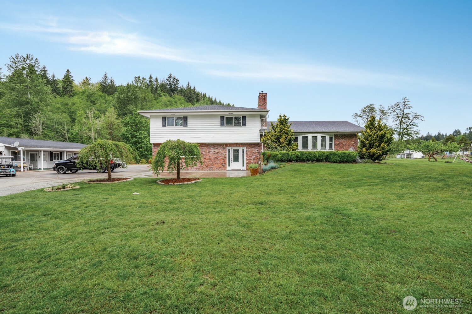 Opportunity to own private country estate w/ built-in income potential on 3.32 usable acres, 15 minutes to dining, shopping & Riverside Golf Course. Property borders Coffee Creek. The 2,233 sq ft main home w/ 3 beds & 2.5 baths w/updates throughout, including slate entry, newer roof, vinyl windows, forced air w/ heat pump & attractive tile flooring. Living room w/ propane fireplace. Kitchen w/ walnut cabinetry, Corian countertops, coffee bar w/ sink & eating space w/ sliders to backyard for indoor/outdoor living. Formal dining area w/ French doors leads to patio for entertaining. Primary suite w/ 2 walk-in closets & private bath. Outdoor living w/ covered patio w/ stamped concrete, pond, above-ground pool w/ deck, sport court, greenhouse & garden area w/ raised beds. Many fruit trees, goat & chicken pen/coop & well w/ sprinkler system make property ideal for self-sufficient lifestyle. Adding value are 3 rental units on property, making this an option for owner-occupants wanting to offset their mortgage or investors seeking multiple income streams: 3-bedroom, 2-bath single-wide w/ long-term tenants paying $2,000/month (also leasing shop & covered storage), 1-bedroom, 1-bath apartment w/ office/bonus room (being used as 2nd bedroom) renting for $1,600/month, 2-bedroom, 1-bath apartment renting for $1,700/month. Property includes shop, covered storage & large parking area for work trucks, equipment, or recreational vehicles for contractors, hobbyists, or business owners.