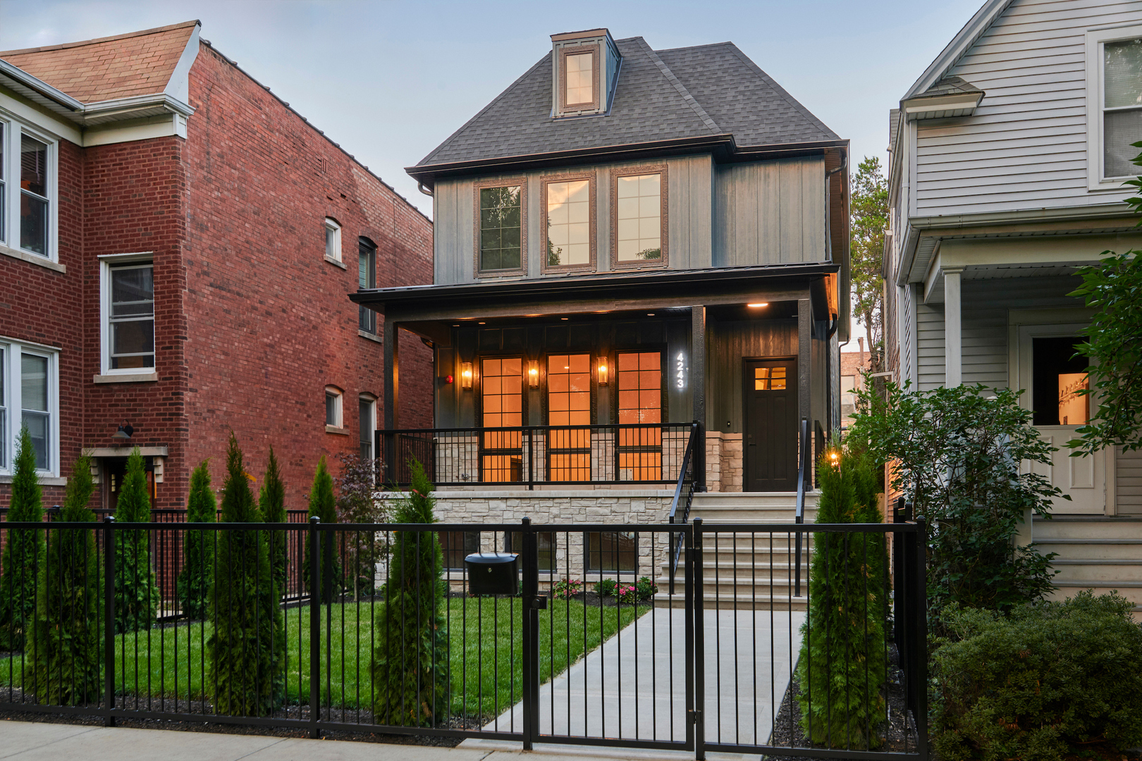 Tucked behind a storybook front yard on a tree-lined block, this newly constructed home with interiors by Hubbard Design Group blends playful warmth with quiet sophistication. Set on an extra-wide and extra-deep 30' x 154' lot, the home is set back from the street, giving you a broad green lawn and a welcoming 9-foot covered front porch. It's the kind of yard that begs for sidewalk chalk, lemonade stands, and slow Sunday mornings; equal parts privacy and presence.  Inside, timeless elegance meets modern comfort. White oak flooring, subtle millwork, and airy 10-foot ceilings lend every room a sense of refined ease. At the front of the home, the formal living and dining room is anchored by a gas fireplace with a hand-finished surround, flanked by tall windows, perfect for holiday dinners or cozy evenings in. Beyond a graceful arched, wide hallway, the heart of the home opens up: a show-stopping kitchen and family room that balances function and form. The double-sided island seats five, topped with Calacatta quartzite. Custom off white cabinetry frames two 30" built-in refrigerator and freezer columns and pairs with a Wolf 48" gas range. A hidden scullery with a second dishwasher and sink makes entertaining effortless and everyday life beautifully contained. Designer tile accents and a full-height backsplash add visual richness. Arched built-ins surround the family room fireplace, and natural light pours in from all sides. Downstairs, the fully radiant-heated lower level is designed for real life. Host movie nights in the rec room, store your favorites in the glass-enclosed wine cellar, or retreat to the spa-inspired 7' x 9' sauna after a long day. There's also a guest suite with a full bath, a flex space perfect for a gym or sixth bedroom, and a wet bar with designer fixtures for good measure. Upstairs, family living is reimagined. Four bedrooms-three with ensuite baths-provide comfort and autonomy. The primary suite, thoughtfully located at the front of the home, offers peaceful treetop views and sunlight throughout the day. A spa-inspired bath features heated floors, a soaking tub, a luxurious walk-in steam shower and a private water closet, while a spacious walk-in closet keeps everything in order. And then there's the train-yes, it's behind the house. But what could have been a flaw has been reimagined. The home was pushed back on the lot, creating the deep front yard and engineered acoustics that make the occasional rumble feel more like a hum-city energy at a gentle distance. Inside, you'd hardly notice. Outside, you're reminded that convenience lives just steps away. Location-wise, 4243 N Wolcott straddles the line between North Center and Ravenswood, claiming the best of both. You're in the desired Ravenswood Elementary district - a big plus for families seeking excellent public schools. Within blocks, you'll find family essentials and neighborhood charm in every direction. Saturday mornings start at the Northcenter Farmers Market, where live music, pastries, and produce are as much a ritual as a resource. Grab coffee at Spoken or Hexe on your stroll home, or treat the family to breakfast in the garden courtyard at Willow Cafe and Bistro. When dinner rolls around, options abound: sizzling Korean BBQ at Cho Sun Ok, wood-fired pies from Spacca Napoli, or a burger at The Bad Apple. Family-friendly breweries like Begyle, Half Acre, and Dovetail offer relaxed patios, food trucks, and community vibes where strollers and pints are equally welcome. And with beloved local events like Ribfest, Harvest Jam, and movie nights in Welles Park, the calendar fills itself. This is more than just a home; it's a backdrop for a life with rhythm, intention, and joy. In a city that often asks for compromise, 4243 N Wolcott gives you space, style, and neighborhood spirit without asking you to give anything up.