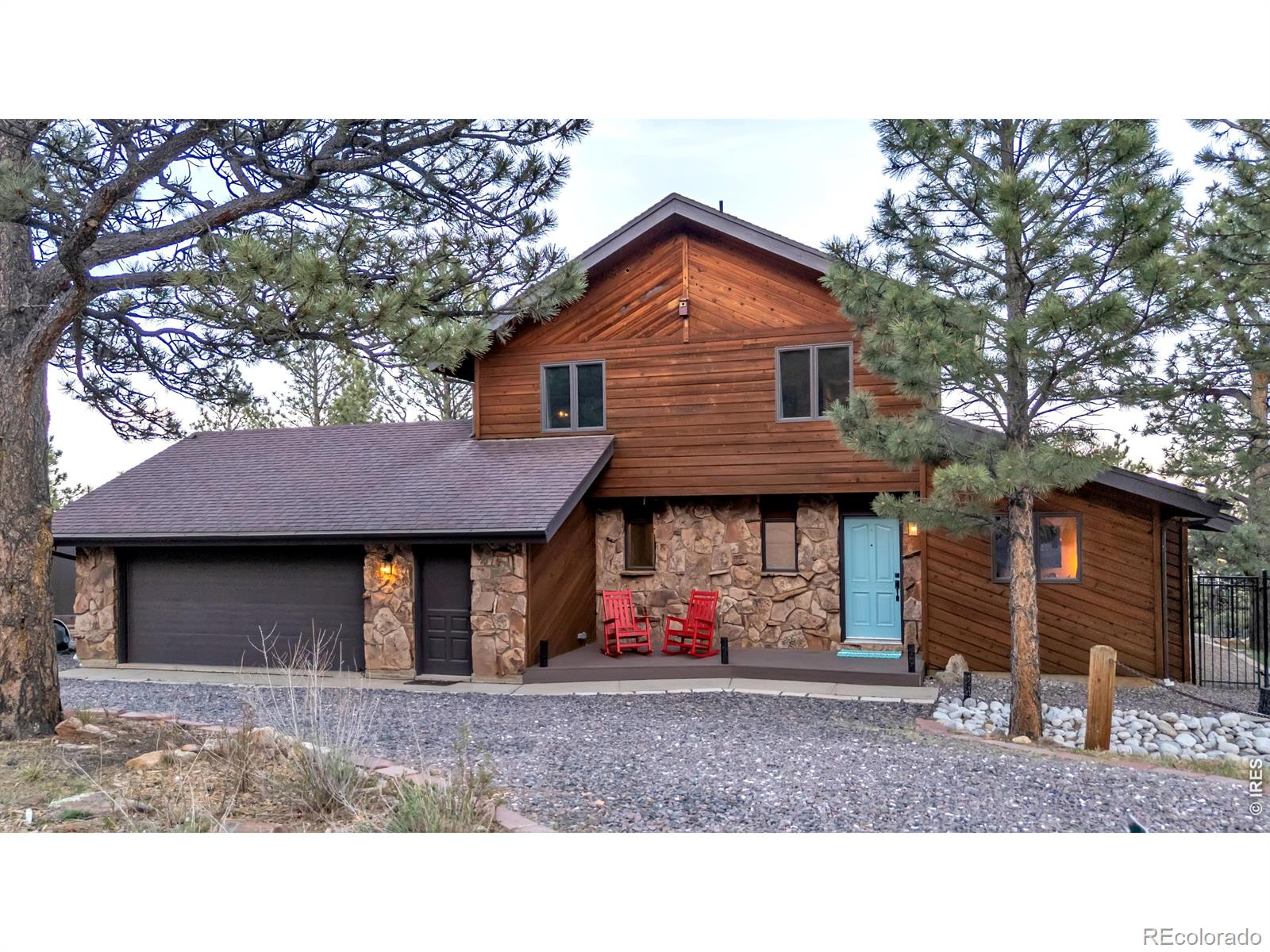 A Haven Above It All. Perched atop Crestview Estates, one of the most sought-after mountain communities just outside Boulder, this extraordinary home captures breathtaking panoramic views stretching from Boulder Reservoir to the Denver skyline, with the iconic Flatirons rising in the distance. Mountain living is experienced in a thousand small moments-morning coffee as the sun rises over the horizon, quiet evenings on the deck surrounded by whispering pines, and the sense of peace that comes from being immersed in nature while remaining just minutes from everything Boulder has to offer. This thoughtfully updated home offers 2,606 square feet of living space with 4 bedrooms, 3 bathrooms, and a separate studio/office, ideal for working from home, creative pursuits, or flexible living. Warmth, style, and functionality blend seamlessly throughout. At the heart of the home is a beautifully designed chef's kitchen featuring butcher block and granite countertops, premium appliances, and a charming coffee nook that invites slow mornings and easy entertaining. Hickory wood floors throughout, updated lighting, and carefully curated custom details create a timeless aesthetic that feels both elevated and comfortable. Designed to embrace its spectacular setting, the property features three brand-new decks, including a private balcony off the primary suite. Outside, you'll find something rarely available in mountain communities, expansive, usable outdoor space. The large yard includes a dog run, garden areas, and level terrain with room for an RV, camper, trailer, or all of your Colorado adventure gear. Offering peace, privacy, and incredible scenery just minutes from downtown Boulder, this is mountain living without compromise.