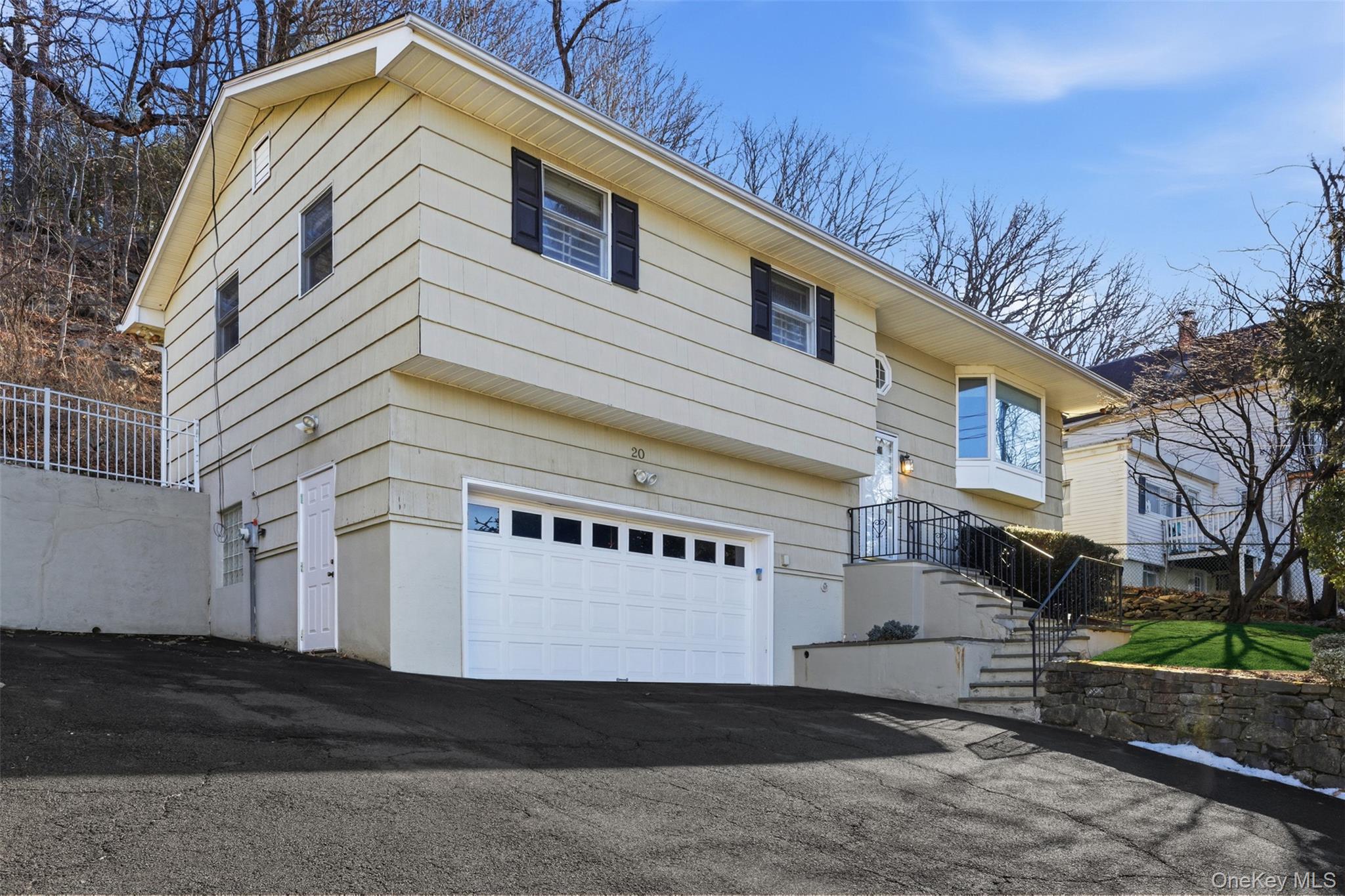 Welcome to this move-in-ready 3-bedroom, 2.1 bath home located in the heart of North White Plains within the Valhalla School District. The home has been freshly painted, and the floors have been refinished and stained. The living room and primary bedroom feature vaulted ceilings, creating a bright and airy atmosphere throughout.The first floor offers a welcoming living room, a primary bedroom with a skylight, and a full bath. Two additional bedrooms and another full bath provide a comfortable and functional family living space. The convenient layout features an eat-in kitchen, pantry, and laundry space, with sliding doors that open to a bluestone patio and a fully fenced yard—ideal for indoor-outdoor living and entertaining.The lower level includes a spacious family room, a convenient butler’s pantry area with abundant cabinetry, a full bath, and ample storage throughout the home. Parking includes a two-car garage plus additional driveway space. Ideally located less than one mile from the North White Plains Train Station and the Bronx River Pathway. Just minutes from the scenic Kensico Dam Plaza, known for beautiful bike trails and popular year-round events, including Fourth of July fireworks and Winter Wonderland. Close to Valhalla schools, the village center, and Armonk/North Castle recreation.Discover the potential in this wonderful opportunity to make this commuter's dream home your own.