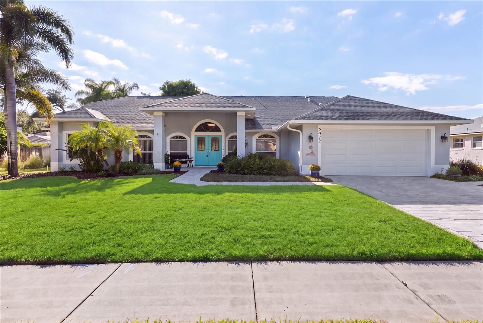 2972 Glenpark Rd offers a rare combination of space, updates and private outdoor living in Palm Harbor. This 4-bedroom, 2-bath, one-story residence offers 2,353 heated square feet on a 0.27-acre lot and features a private 36' x 23' screened pool. The interior is designed around an open great room floor plan, creating versatile spaces for everyday living and entertaining. Vaulted ceilings and high ceilings add volume to the main living areas, while the main-level primary bedroom includes a walk-in closet. Built-in features, ceiling fans, window treatments, ceramic tile and laminate flooring provide a practical mix of comfort and function.The kitchen is equipped with a convection oven, dishwasher, disposal, exhaust fan, microwave, range, range hood and refrigerator, with high  bar perfect for afternoon snacks. The home also includes an electric water heater, washer and dryer, central air, central and electric heat, and a heat pump. Security features include a security system, smoke detectors, secured garage/parking and security fencing, lighting and alarms. The property also features public water, public sewer, reclaimed irrigation, rain gutters, underground utilities and a paved street with sidewalks.A notable feature of the property is the extensive history of improvements. The shingle roof was installed in 2018, followed by the HVAC system in 2020. The primary bathroom was remodeled and the variable-speed pool pump was installed in 2021. In 2023, the property received brick pavers at the driveway, porch and pool, family room built-ins, electric fireplace, two garage storage rack units and hurricane screening for the lanai area. The garage door was upgraded to hurricane-rated construction in 2024, along with the installation of a new water heater. In 2025, additional improvements included a water softener, garbage disposal and termite prevention system.The screened pool and surrounding outdoor space create an inviting extension of the home. Measuring approximately 36' x 23', the private pool features gunite/concrete construction, lighting, pool sweep, tile and paver deck. The property also offers covered and screened outdoor areas, a front porch, rear porch, deck and sliding doors. Mature landscaping and trees, together with irrigation and rain gutters, complement the exterior, while vinyl fencing provides additional privacy and definition.Located in Eniswood in Palm Harbor, this residence offers a generous 0.27-acre lot with mature landscaping and trees, a private 36' x 23' screened pool and multiple outdoor living areas. Combined with the open floor plan, main-level primary bedroom and extensive history of improvements, 2972 Glenpark Rd offers a well-appointed residence with substantial updates and inviting private outdoor living.