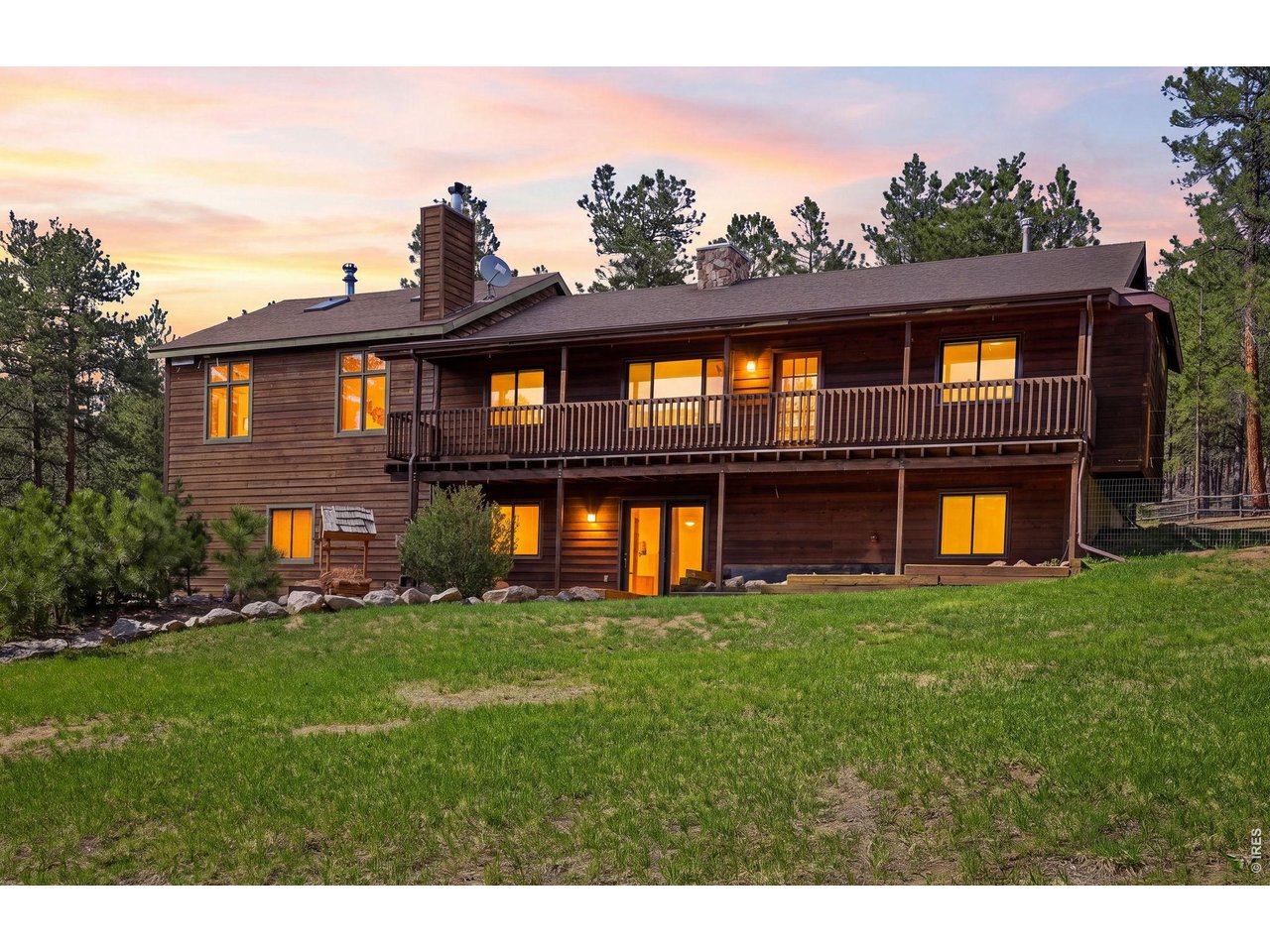 Escape to thirty-five acres of privacy in this mountain retreat located thirty minutes from Loveland and Carter Lake. This expansive property features easily accessible acreage for recreation or a hike up your private trail to the ridge for incredible valley views. The primary bedroom offers a serene atmosphere with large windows, a skylight, and a wood-burning stove, while the above-ground walkout basement adds versatile space. Hobbyists will love the nearly 2,000 square foot outbuilding with oversized doors, complemented by a south-facing driveway, chicken coop, and terraced garden beds. Located under 10 minutes from Pinewood Reservoir (kayaking, SUP, trout fishing and camping), this is an ideal year-round home or weekend getaway cabin for residents in Boulder, Longmont or Fort Collins, all about an hour away.