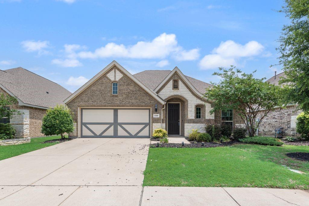 Welcome home! Gehan Builder, this home offers exceptional curb appeal with its gorgeous brick and stone elevation, lush landscaping, and a two car garage. This home impresses with its elegant arched entry and beautifully manicured yard. Step inside to a bright and open foyer showcasing rich hardwood flooring that flows throughout the main living areas. The versatile front room provides the perfect space for a formal dining room or additional living area. The home has an expansive open-concept living room featuring soaring vaulted ceilings, a cozy wood-burning fireplace, a ceiling fan, and plenty of natural light. The living room opens seamlessly into kitchen. The kitchen comes with granite countertops, island, and stainless steel appliances include a French door refrigerator, gas cooktop, built-in double oven, microwave, and dishwasher. The primary suite is nicely sized with an ensuite bathroom. Primary bath has dual sinks, granite countertops, a relaxing garden tub, a separate walk-in glass shower with tile walls, and tile flooring. The large walk-in closet offers built-in shelving and multiple hanging rods to accommodate any wardrobe.Two additional bedrooms offers ceiling fans and ample natural light. The bonus room with French doors is perfect as a home office, study, playroom, or flex space to suit your lifestyle needs.Outdoor living is a delight with a covered back patio overlooking the large, fully fenced backyard with beautiful green grass great for entertaining, play, or relaxing evenings. The dedicated indoor laundry room includes built-in shelving and space for a full-size washer and dryer.Enjoy resort style community amenities including a swimming pool, park, and scenic walking trails. Schedule your showing today!