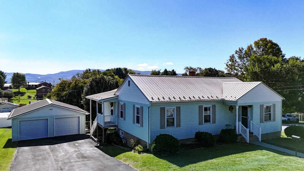 Spacious, well-maintained ranch-style home with a two-car garage in Wytheville, Virginia. The main level offers three bedrooms, two full baths, hardwood flooring throughout most rooms, and generous gathering space created by an addition. The finished basement provides flexible space for an in-law suite or other living arrangement, along with a third full bath and laundry area. Vinyl windows, gas heat, air conditioning, and a metal roof add comfort and durability. The addition also creates an inviting outdoor gathering area overlooking the large backyard and mountain views south of town. Updates to the kitchen and baths could further enhance the home, but it is already move-in ready and impressive. Convenient to I-81, shopping, and medical services, the property sits in a quiet, private neighborhood on an elevated lot above many neighboring homes.