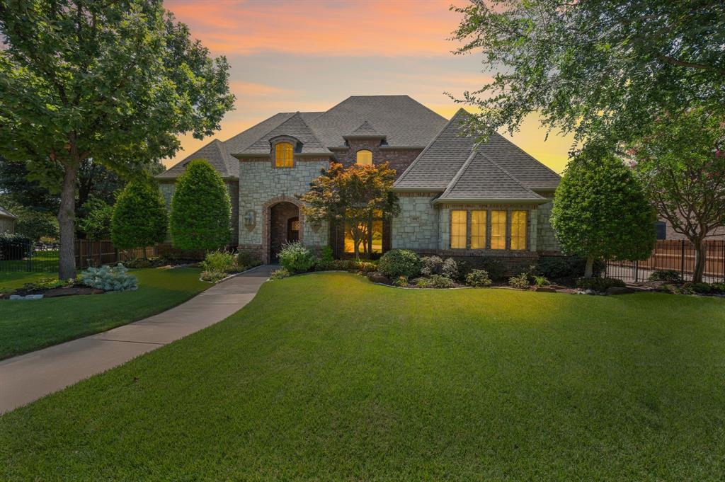 This stunning home features an open-concept kitchen, spacious living area, and a large breakfast nook centered around a beautiful stone fireplace—all with views of the sparkling pool. You’ll find abundant storage throughout, including a generous walk-in attic. Rich woodwork adds warmth and elegance, and a custom staircase leads to a classic office adorned with beams and built-in shelving. Two bedrooms are located on the main floor, while the upstairs offers two additional bedrooms, two full bathrooms, and a versatile game room-theater room. Thoughtful design elements include charming hidden nooks tucked behind bookcases in the upstairs bedrooms - optimal for a playroom, study area or storage. Step outside to an expansive patio overlooking a picture-perfect pool and spa, surrounded by lush landscaping. The outdoor living space includes a cozy fireplace and built-in grill, ideal for entertaining. Large modern pavers provide a clean aesthetic and lead to additional green space behind the pool. Enjoy direct access to the Cottonbelt Trail, perfect for walking, jogging, or biking. Ideally situated near Highways 26 and 114, with convenient access to premier shopping and dining in Colleyville and Southlake—and just minutes from DFW Airport.