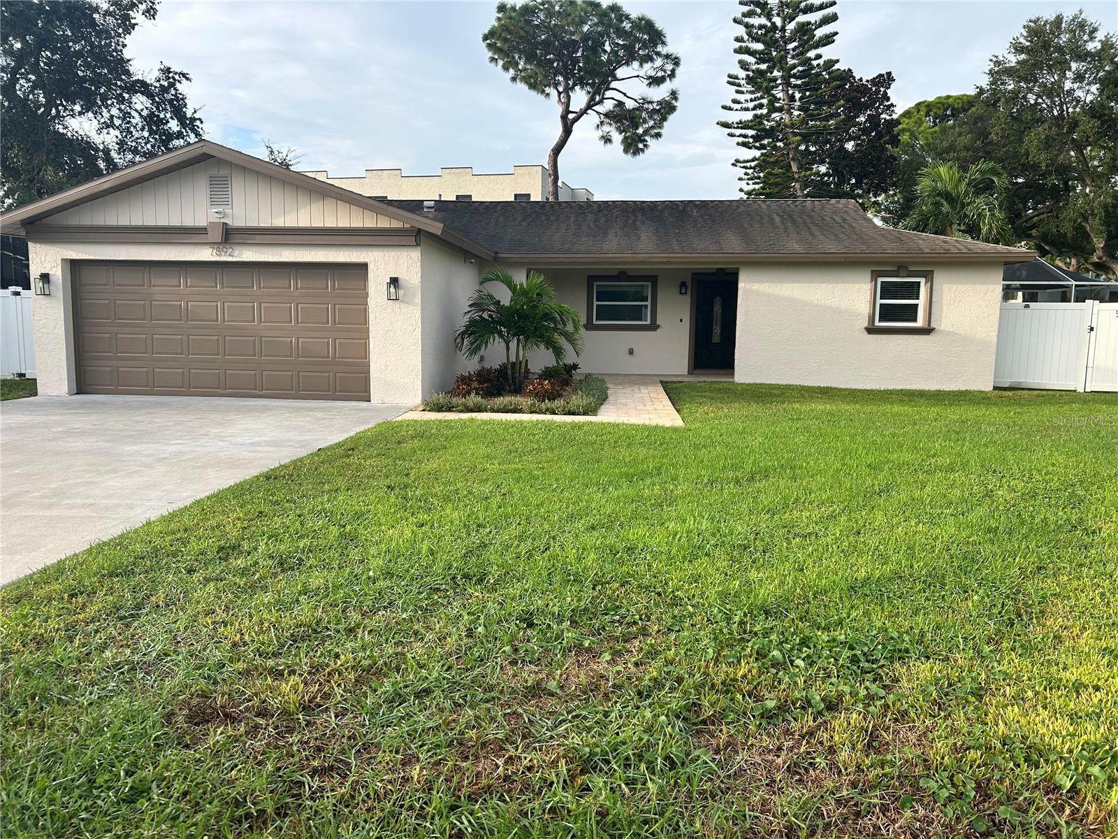 Charming Pool Home with Modern Updates, Solar & Hurricane ProtectionWelcome to this inviting 3-bedroom, 2-bathroom pool home with a 2-car garage, tucked away in a quiet, established neighborhood in unincorporated Pinellas County. Peacefully situated off the beaten path yet conveniently close to beaches, shopping, dining, schools, and major transportation routes, this residence offers an appealing blend of comfort, privacy, and convenience.From the moment you enter, the home's open-concept floor plan creates a warm and welcoming sense of space. The heart of the home is the spacious great room, where a beautiful stone fireplace provides an inviting focal point and large views toward the screened-in pool create an effortless connection between the indoor and outdoor living spaces.The kitchen opens seamlessly to the great room and has been thoughtfully enhanced with newer cabinetry and appliances, making it both functional and stylish for everyday living and entertaining.The private primary suite offers a peaceful retreat, complete with an en-suite bathroom, a generous walk-in closet featuring newer cabinetry, and French doors opening directly to the pool area. Two additional bedrooms and a second full bathroom are situated on the opposite side of the home, providing comfortable separation and flexibility for family, guests, or a home office.Step outside and discover your own private oasis. The screened-in pool area provides an ideal setting for morning coffee, afternoon relaxation, or entertaining guests year-round. A small backyard shed adds convenient additional storage, while the home's paid-for solar panel system offers an added energy-conscious feature.Designed with Florida living in mind, the property also features Kevlar hurricane window coverings, providing an additional layer of storm protection and peace of mind. The current owner states that neither the home nor the Sundown neighborhood has ever flooded.The oversized 2-car garage provides ample parking and storage and includes a full-size washer and dryer for added convenience.Despite its tranquil setting, the home is remarkably close to the area's everyday amenities and attractions. Northside Christian School is approximately 2 minutes away, grocery stores and restaurants are about 5 minutes away, and Madeira Beach and Tyrone Mall are each approximately 15 minutes away. Tampa International Airport is approximately 20–25 minutes away. Nearby Joe's Creek also offers year-round fishing for those who enjoy spending time outdoors.Quiet surroundings, a private pool, open living spaces, modern kitchen updates, solar power, hurricane protection, and an enviable Pinellas County location come together to create a home that is as practical as it is inviting.
