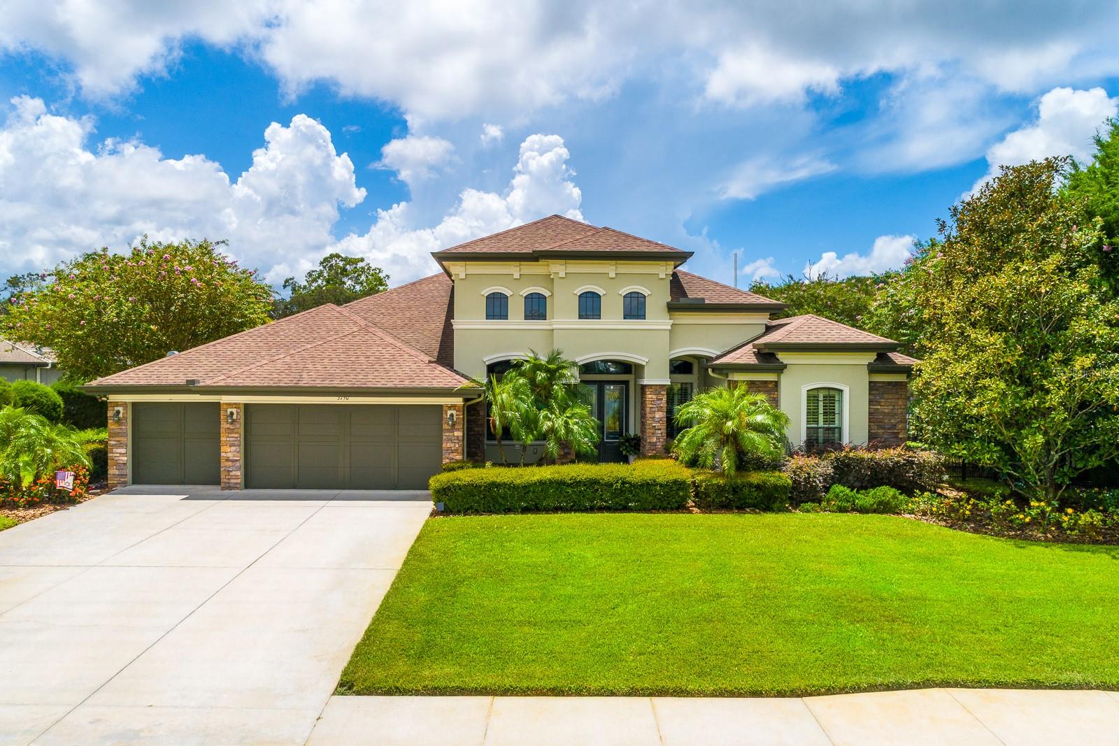 Welcome to Foxwood Estates – Tarpon Springs’ hidden enclave of luxury living. Behind the gates of this exclusive 10-home community, discover a custom-designed estate perfectly positioned on a serene .97-acre homesite with sweeping views of lush green space and a tranquil pond beyond. A long, stately driveway leads you to the elegant double-leaf entry doors, opening to a sun-drenched foyer and soaring ceilings. Rich wood flooring flows throughout most of the home, setting the stage for refined living. The thoughtfully designed split floor plan offers 4 spacious bedrooms, 3 full baths, and versatile living areas, including formal living and dining rooms, a coffered-ceiling family room with a stone-accented gas fireplace, and a private in-law-style suite with its own sitting area, bath, and direct patio access. The gourmet kitchen is a chef’s dream, showcasing a grand center island, 42" maple cabinetry with roll-outs, granite countertops, gas cooktop, KitchenAid Multi-Door Refrigerator, reverse osmosis water system, tile backsplash, and under-cabinet lighting. The adjoining breakfast nook frames picturesque views of the pool and outdoor living area. The owner’s retreat is a true sanctuary with a tray ceilings, private sitting area, multiple closets—including a custom walk-in with built-ins (you have to experience!)—and a spa-inspired bath with dual granite vanities, a soaking tub, and a separate shower. Step outside to an entertainer’s paradise: an expansive covered lanai, an outdoor kitchen with a DCS grill, a two-burner cooktop, and mini-fridge, a sun-shelf PebbleTec pool with brick pavers, and space for lounging, dining, and even sunset swings. Beyond the screen enclosure, your private backyard opens to a manicured lawn and majestic trees, offering peaceful privacy. Additional features include plantation shutters, double crown molding, 5-inch baseboards, thermal windows, radiant barrier protection, an epoxy-finished 3-car garage, and more. Here, every detail speaks of quality, comfort, and elegance. This rare offering in gated Foxwood Estates blends timeless design, luxurious finishes, and unparalleled privacy—yet keeps you just minutes from both Palm Harbor and Tarpon Springs’ charming shops, dining, award-winning Gulf beaches, and only a short drive to Tampa for endless entertainment options.