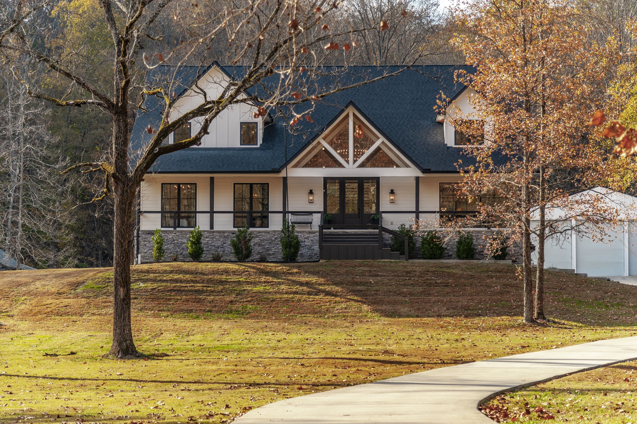Welcome to this custom-built modern farmhouse on 6.8 private acres, complete with a 60x40 barn/workshop featuring its own bathroom. Designed for both everyday living and effortless entertaining, this home offers an incredible blend of style, function, and space. The entertainer’s kitchen is a true showpiece—highlighted by a massive 11x9 steel-reinforced island, custom window package, and NanaWall-style windows and sliders that blur the line between indoors and out. A full butler’s pantry and dual-sided bar service area elevate hosting, and the custom-built dining table (crafted inside the home to seat 16) remains with the property.A sunken hot tub is already in place, and an in-ground pool could easily be added—renderings and a contractor bid are available by request for buyers interested in future expansion.Upstairs offers a large bonus room with craft area, four bedrooms, and excellent storage throughout. The oversized garage provides abundant space for outdoor enthusiasts—bring a boat, ATVs, and more—plus additional outdoor toy storage. The primary suite includes a hidden storm shelter/safe room discreetly accessed through the closet.The walk-out basement is a dream hangout space featuring two queen-sized bed loungers, a gym area, media setup, and room for future expansion or storage.