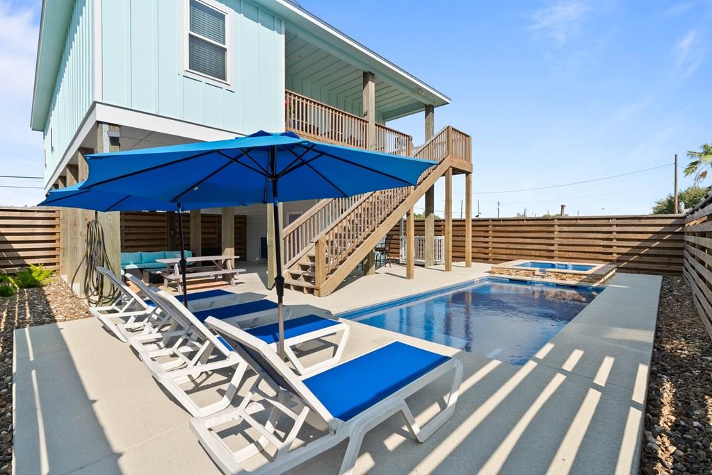 Fully Furnished & Ready for Fun! This ideally located retreat is pre-programmed for giggles, laughter, and countless memories waiting to be made. Step into your personal slice of paradise where relaxation meets recreation. The sparkling pool and hot tub are just the beginning—whether you're lounging under the sun or soaking under the stars, every day feels like a vacation here. Enjoy low-maintenance landscaping, a boat garage, attached carport, and a cargo lift for easy living. The outdoor entertaining areas, both upstairs and down, are designed for gathering, grilling, and good times. Imagine watching your favorite college game poolside, with an ice-cold drink whipped up at your pool cabana bar, while friends and family cheer! Inside, the open-concept floor plan flows effortlessly, creating the perfect backdrop for late breakfasts after long days of sun and salt air. The living area invites cozy conversations, laughter over shared meals, and evenings filled with the glow of golden sunsets streaming through generous windows. Fully furnished and styled for comfort, every detail has been thoughtfully chosen to make your stay effortless from day one—just bring your flip-flops and favorite playlist. Whether you're looking for a weekend getaway, vacation rental investment, or full-time coastal escape, this property delivers the perfect blend of style, function, and pure fun. From the moment you arrive, you'll feel it—this isn't just a house, it's a feeling. Your next adventure begins here, and the memories are waiting to be made!