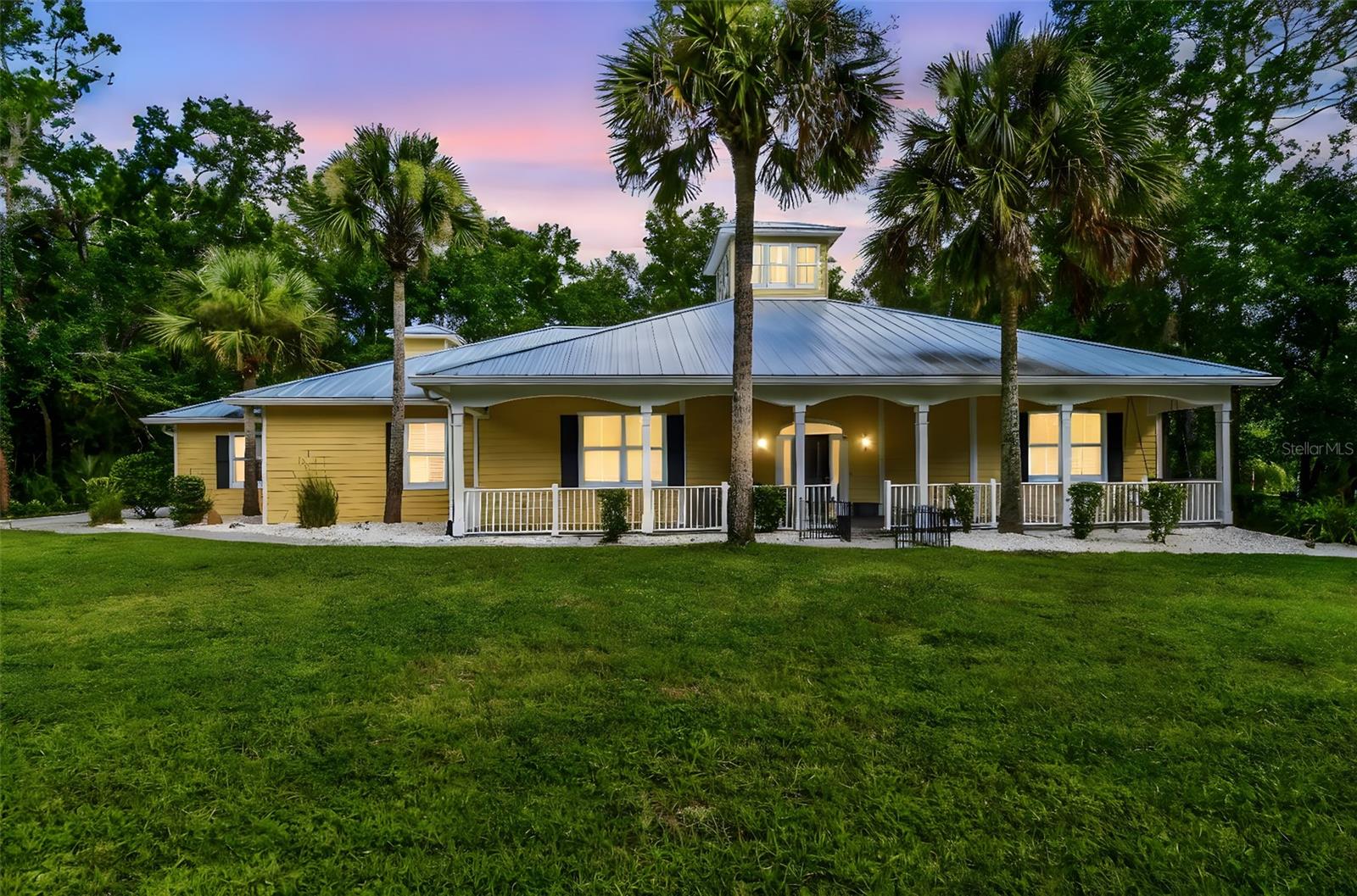 Under contract-accepting backup offers. Tucked away behind a private, gated entrance and surrounded by almost 6 acres of serene land, this one-of-a-kind Key West-style retreat offers a lifestyle of peaceful seclusion with every modern upgrade already done for you. As you travel down the long drive, you'll be welcomed by your very own botanical sanctuary—think 5 acres of natural Florida beauty filled with cypress trees and wildlife, all protected conservation wetlands that will never be built on. The moment you step onto the wide paver path leading to the expansive front porch, you’ll know you’ve arrived somewhere special. Inside, elegance meets craftsmanship in a grand foyer that opens into a dramatic great room, anchored by a central whale watch tower soaring 25 feet high with twelve windows that flood the space with golden natural light. Italian travertine tile flows throughout the home, complemented by double crown molding and fine finishes at every turn. The gourmet kitchen is an entertainer’s dream, featuring 42-inch espresso wood cabinetry, a gas range with pot filler, stainless steel apron sink, granite countertops, a new refrigerator (2023), and double convection wall ovens—all designed to inspire your inner chef. This spacious layout includes four bedrooms and three full bathrooms, each with direct access to a walk-in shower and walk-in closet—ideal for multi-generational living or guest privacy. The fourth bedroom easily transforms into a home office or creative studio. The oversized primary suite is a true sanctuary, offering private access to the patio and hot tub. The ensuite bathroom is spa-worthy, complete with dual vanities, a large jetted soaking tub, a separate toilet room, and a massive walk-in closet. Step through the wall of sliding glass doors and into your own tropical escape: a 23,000-gallon resurfaced pool (2024), paver deck, and built-in stainless steel BBQ station, perfect for hosting. Adjacent sits a 36-jet hot tub with views of your private preserve—pure tranquility. The home also boasts a brand-new metal roof (2024), a new six-zone sprinkler system (2024), a fully fenced yard ideal for pets, and sits over 50 feet above sea level. Don’t forget a large two-car garage, dedicated RV/trailer parking pad, and a separate shed for landscaping tools and mower storage. Plus, with no HOA or deed restrictions, your lifestyle is yours to design. You’ll feel a million miles from it all, yet still close to modern conveniences. Ideally situated near I-75, this location offers effortless commuting to Tampa and beyond. Spend your weekends exploring the Tampa Premium Outlets or Shops at Wiregrass, just a short drive away. Golf enthusiasts will love the easy access to nearby courses, while a wide variety of shopping, dining, and entertainment options ensure there’s always something to enjoy close to home. Homes like this don’t come around often, schedule your private tour today and discover the magic of true Florida living.