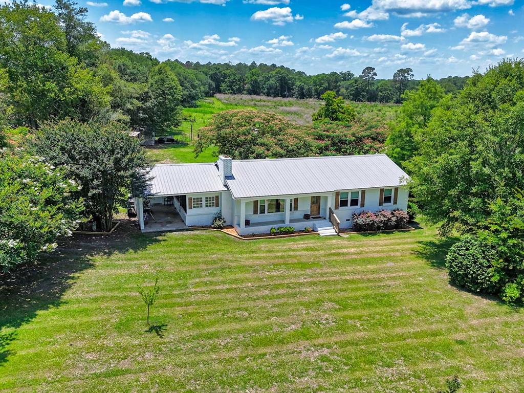 Nearly 23 acres of highly usable land with good soils and a pond, making it an excellent dog training tract or the perfect setup for cows, horses, or other livestock. The pasture is already fully fenced and ready to go, offering endless opportunities for farming, recreation, or peaceful country living. There's also a home on the property, making this an ideal turnkey homestead or hobby farm opportunity.  Welcome to peaceful country living with all the modern updates already done for you. Situated on nearly 23 beautiful acres, this 3-bedroom, 2-bath home offers the perfect blend of comfort, functionality, and room to grow. Inside, you'll love the bright open floor plan designed for both everyday living and entertaining, featuring luxury vinyl flooring throughout for a seamless, low-maintenance finish.  The beautifully updated kitchen opens directly into the spacious living and dining areas, creating a warm and inviting atmosphere filled with natural light. All kitchen appliances, along with the washer and dryer, will remain with the home, adding even more convenience for the next owner. The home offers just the right amount of space while still allowing endless possibilities to expand, add outdoor features, or simply enjoy the privacy and acreage this property provides.  A screened-in porch creates the perfect spot to relax and take in the peaceful surroundings year-round. Outside, the nearly 23 acres provide plenty of room for recreation, gardening, livestock, additional structures, or future improvements. The property also features a wonderful variety of fruit trees and berries, including tangerines, figs, muscadines, persimmons, plums, blueberries, and wild blackberries — adding both charm and functionality to this already impressive property.  Major updates provide peace of mind, including new windows and a new HVAC system installed in 2024, a water heater that is only 6 months old, and a roof replaced in 2018.  Conveniently located just 20 minutes to downtown Thomasville, 15 minutes from downtown Cairo, and only 10 minutes from Pelham, this property offers the ideal balance of privacy and accessibility. Whether you're searching for a private homestead, hobby farm potential, or simply more space to spread out, this property delivers the best of quiet country living with modern comfort.