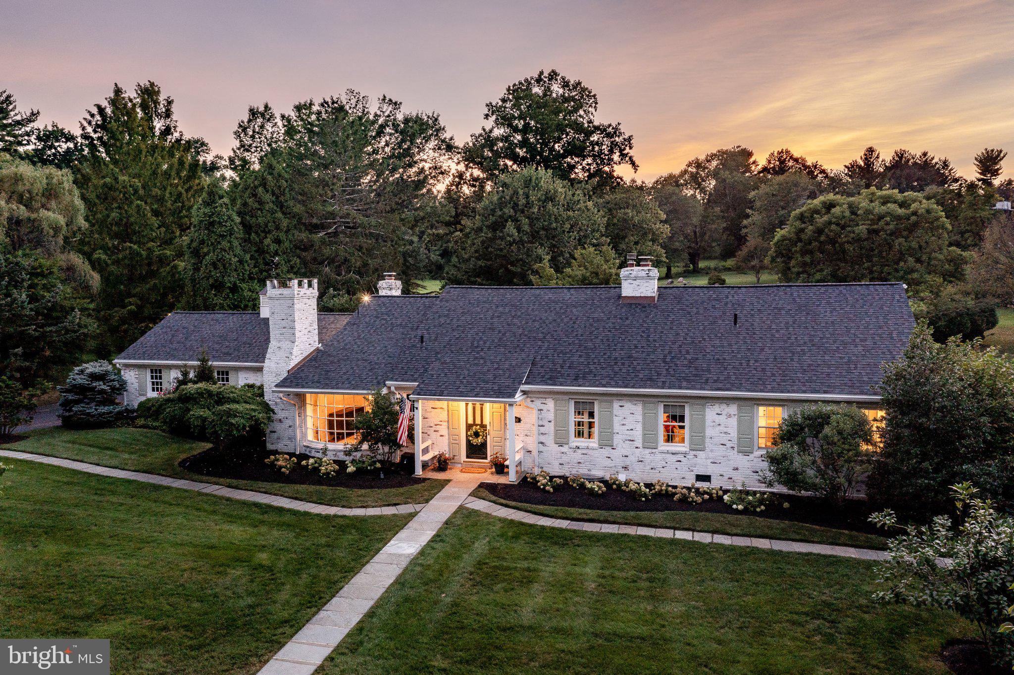 OPEN HOUSE CANCELED. Just beyond two pillars, this Quintessential Main Line Estate will enchant you. 1300 Morris Aveis set on 1.26 serene acres with a mature tree border along Private Morris Rd & the PrestigiousGolden Mile of North Spring Mill Rd. This Villanova Cape Cod-style home offers a privatesanctuary, charming brick architecture, seamlessly blending old-world charm with extensiverenovations and upgrades, offering classic Main Line curb appeal and move-in-ready luxuries.Boasting 4,483 sqft above-grade living space plus a newly finished Designer Kitchen and lowerlevel, this residence features 5/6 Bedrooms and 5.5 Bathrooms, with a first-floor primary suite.Flooded with natural light, the interior features rich hardwood flooring, beautiful moldings,recessed lighting, and three cozy fireplaces. Main-level living areas include a formal dining roomwith a wall of windows and stone-surround fireplace, an inviting living room with fireplace andpicture window overlooking the grounds, and access to the expansive bluestone patio. A newlycompleted Designer eat-in kitchen features custom white and walnut cabinetry, quartzcountertops, generous seated island, Thermador appliances including two ovens, microwave, andprofessional cooktop & hood, designer tile backsplash, new pantry and mudroom area. Frenchdoors open to a dedicated office/library with built-in shelving and gas fireplace. Down the hall isa spacious bedroom with newly renovated bath, including a designer double sink vanity, large walk-inshower, and a renovated laundry room with custom built-in cabinetry. The primary suite offers aspacious retreat with a neutral white bath, walk-in shower, and additional built-in storage.Adjacent to the primary suite, a versatile bonus room with its own patio offers possibilities as anursery or walk-in closet dressing room, with potential for future primary suite expansion. Threeadditional spacious bedrooms upstairs provide guest privacy and comfort. Each has an ensuite oradjacent bath and ample storage, including a linen closet, suitcase storage closet, and atticstorage. Downstairs, the newly finished daylit lower level creates flexible living space for ahome gym or rec room with new LVP flooring.The rear of the property is enchanting with multiple covered & uncovered seating and loungingareas overlooking a sparkling pool and ample grounds for your favorite sport. Extensivehardscaping & landscaping enhancements, privacy tree plantings, & selective clearing havemaximized usable outdoor space for seasonal entertaining. A picturesque pond tucked at thecorner of the property has been newly transformed with a cascading waterfall, serving as thejewel of the outdoor living experience, fully stocked with fish and fenced in.The current owners have invested extensively in virtually every major system & finish, allowingthe next owner to simply move in and enjoy life’s little luxuries and peace of mind. Recentupgrades include: electrical panels w EV charger; architectural roof/siding/gutters; HVACsystems; whole-house insulation; replacement windows; plumbing updates; professionallypainted interior and exterior, designer wallpaper & light fixtures throughout, pool resurfaced &retiled. Peace of mind comes with a whole-house generator.Offering convenience with an attached 2-car garage, long driveway w ample parking, directwalkway access to “private Morris Rd” for school bus pickup, children's play & bike riding,abutting the iconic Red Rose Farm. Located approx 1 mile from Villanova University andVillanova Train Station, minutes from Appleford Gardens, within top-rated Lower Merion SchoolDistrict, Bryn Mawr dining, Markets, premier regional shopping, & easy highway access toPhiladelphia’s downtown.