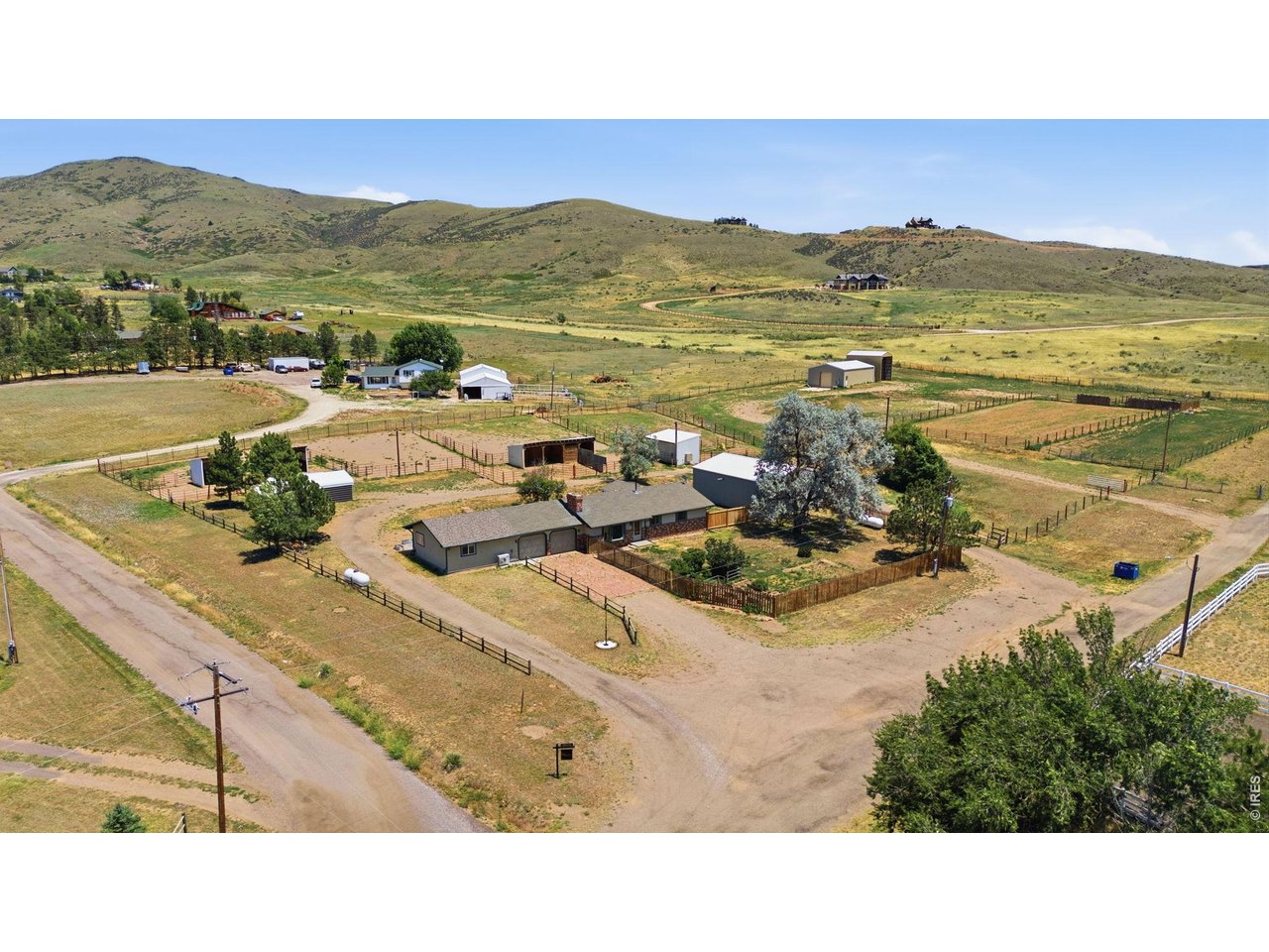 Country living with room for horses, hobbies and multigenerational living- all just minutes from Loveland. Situated on 4.33 acres, 6701 Orchard Drive pairs a comfortable ranch-style home with a fully equipped secondary living suite, extensive equestrian amenities and exceptional shop/storage space. The main residence offers 3 bedrooms and 2 baths with warm wood flooring, an inviting living room with brick fireplace, and an updated kitchen featuring granite countertops, copper sink, SS appliances and gas range. The primary suite includes a private bath plus an adjoining bonus room/office. A connected, yet private, secondary living suite adds incredible flexibility with its own full kitchen, living area, bedroom, walk-in closet and 3/4 bath. Wide 36-inch doorways, no stairs, separate heating and A/C make the space especially versatile for guests, extended living or a private work-from-home setup. Outside is where this property truly stands apart. The equestrian setup includes a large fenced riding arena, five paddocks, shelters, hay storage and a custom tack room. Two outbuildings provide exceptional space for equipment, vehicles, workshops and hobbies, while two RV hookups add even more flexibility. Relax or entertain on the expansive stamped-concrete patio while taking in the surrounding foothill setting. All of this is just minutes from Devil's Backbone, Bobcat Ridge, downtown Loveland, shopping, groceries and dining. Seller is offering a 1-0 interest-rate buydown-ask for details. Come see just how much 4 acres can offer!