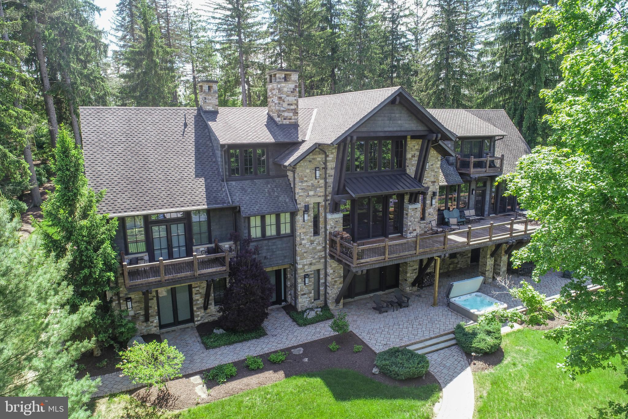 ICONIC. A design masterpiece of stone and timber — a true Rex Anderson build that reflects the seamless merging of inspiration and architecture. Warm, and undeniably welcoming, this home stands as a statement of craftsmanship and vision. Discover a breathtaking blend of contemporary luxury and timeless timber frame construction, perfectly positioned for privacy within the prestigious Reserve at Holy Cross. Surrounded by soaring pines and set against the sparkling backdrop of Deep Creek Lake, this architectural gem offers a flawless fusion of indoor elegance and outdoor serenity. Step inside to soaring exposed beam ceilings, floor-to-ceiling windows, and open, airy living spaces. The great room centers around a striking floor-to-ceiling stone fireplace, complemented by handcrafted timber details and expansive glass doors that open onto a sprawling lakeside deck.  The chef’s kitchen is a modern centerpiece, featuring high-end appliances, granite countertops, custom cabinetry, and a generous island perfect for gathering with family and friends. The primary suite is a luxurious retreat, a spa-inspired ensuite, and dream walk-in closet.  Throughout the home, no detail has been overlooked — from hardwood trim, solid wood doors, all of which, are hand-selected finishes that speak to quality and intention. Additional features include a fully equipped home gym and an energy-efficient geothermal system, ensuring sustainable comfort year-round. Set on 1.3 acres with 160 feet of pristine waterfront, this exceptional property delivers both privacy and proximity to Deep Creek Lake’s finest amenities — from boating and skiing to dining and golf. This is more than a home. It’s a lifestyle. A statement. Welcome to your lakefront legacy.