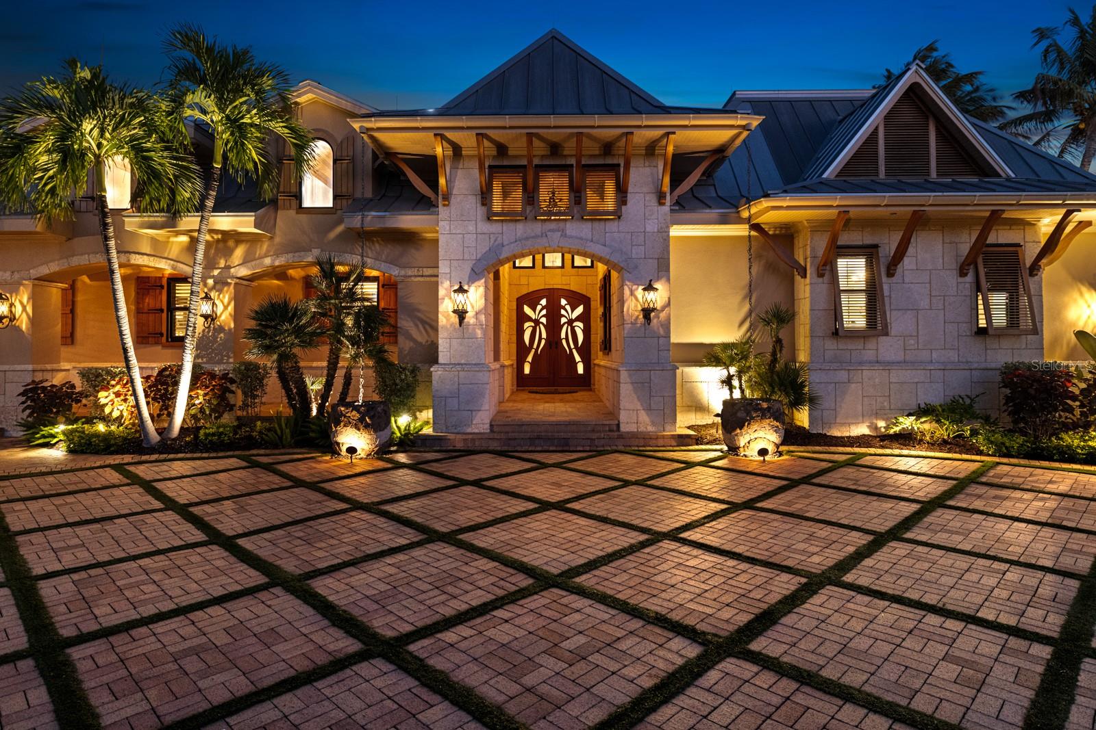 Extraordinary legacy estate in the heart of Boca Grande’s Historic District is a true West Indies–inspired sanctuary where timeless architecture, artisan craftsmanship, and tropical elegance converge. Expansive estate lot, 6,417-sq ft residence offers complete privacy and an undeniable sense of discovery—with enchanting architectural moments revealed around every corner.  Natural stone, rich woods, and refined detailing of understated luxury. Custom mahogany and cypress accents, intricate ceiling designs, sculpted wood columns, and expansive French doors define the home’s open, flowing footprint. Impact-rated windows and doors flood each room with natural light, while it is notable that none of the living areas experienced water intrusion during past hurricanes. Dominican coral stone extends across both exterior and interior surfaces, architectural continuity reinforces the home’s island character.  Designed for effortless gatherings of any size, offers an exceptional array of indoor and outdoor entertaining spaces. Expansive living and dining areas flow seamlessly to beautifully appointed patios, covered lounges, and inviting courtyard retreats. Multiple conversation areas and a well-equipped kitchen make hosting intimate dinners and large celebrations easy. Outdoors, resort-style amenities create a private backdrop for poolside afternoons, evening cocktails, and unforgettable events—an entertainer’s dream. Over 4,000 sq ft of space that opens to a breathtaking courtyard oasis, where cascading waterfalls, lush landscaping and ambient lighting transform the grounds into a private retreat. Stunning heated pool & spa, glass-tile sunshelf complemented by an outdoor kitchen, mosquito-misting system, and whole-property landscape lighting for effortless living year-round. The chef’s kitchen boasts river granite countertops, island, custom cabinetry, premium appliances, and multiple bar areas. Modern technology integrates discreetly with the whole-home Sonos sound system and automated Lutron lighting control. Curated living and entertaining spaces include a gracious dining room, expansive living areas, a dedicated home office, and an upper-level media/entertainment room. The private owner’s wing is an intimate sanctuary with a vast bedroom offering tranquil views across the pool and gardens. The spa-inspired bath offers a luxurious retreat with an oversized walk-in shower, oversized jacuzzi tub, exotic stonework, dual vanities, and elegant lighting. Dual walk-in closets provide generous storage and customization. This 5-bedroom, 6-bath estate offers four additional guest suites, each beautifully appointed with its own ensuite bath, spacious closets, and custom finishes. For boating enthusiasts, the property’s location is second to none—moments from premier local marinas, effortless access to Gasparilla Sound and the Gulf. Enjoy a day of island hopping, world-class fishing, or a sunset cruise, and every adventure begins with ease. Privately enclosed and secured by dual power-operated gates and a paver driveway with decorative turf inlays and a fully gated perimeter for exceptional security and privacy. For pet lovers, dedicated spaces, conveniences, and secure landscaped outdoor areas provide room to roam. Perfectly equipped for pets to enjoy the luxury lifestyle right alongside their owners.The estate is just a golf cart ride from Boca Grande’s world-renowned beaches, shopping, dining, and historic village center—yet feels worlds away.