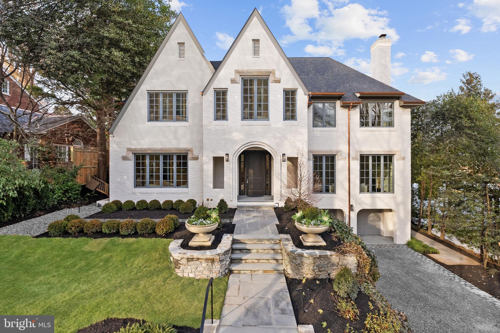 Located in the heart of the estate section of Wesley Heights on a private quarter-acre lot set gracefully back from the street, 4433 Cathedral Avenue is a newly transformed brick Tudor by Madison Investments that masterfully blends timeless architecture with today’s most refined luxuries. With soaring 10-foot ceilings and an exceptional main-level flow designed for elegant entertaining, the home features one of the neighborhood’s largest kitchens and adjoining family rooms—completely rebuilt as part of a top-to-bottom renovation including all-new windows, wide-plank flooring, mechanical systems, chef’s kitchen, and spa-inspired baths.Additional highlights include a screened porch (ideal for seamless indoor-outdoor living), a sun-filled walkout level opening to expansive flagstone terraces, and a spectacular mudroom with custom built-ins and laundry directly off the two-car attached garage. The private owner’s suite is a true retreat, offering two custom walk-in closets, a luxurious oversized bath, a cozy fireplace, and a dedicated office.Spanning approximately 9,570 square feet across four beautifully finished levels with 7 bedrooms, 6 full baths, and a powder room, the residence is complemented by manicured gardens, mature trees, and multiple outdoor entertaining terraces. This extraordinary Wesley Heights offering delivers estate-level scale and sophistication just moments from neighborhood dining, boutique shopping, and Horace Mann ES.