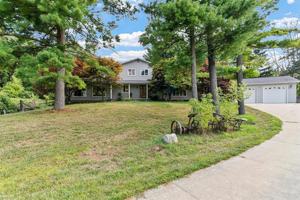 Discover this exceptional custom built, colonial style home nestled on almost 23 acres of serene, private land within the desirable Fenton school district. Offering 4 bedrooms and 3.5 baths, this property combines spacious living with the tranquility of nature and an up-north feel-all just minutes from town. Step inside to find expansive living spaces perfect for both entertaining and everyday comfort. The home features a main floor primary bedroom suite, a spacious firelit family room with a ton of nature light with the floor to ceiling windows, firelit formal dining room, main floor laundry room, a cozy breakfast nook, and the kitchen is designed for gatherings. With two primary bedroom suites, this home offers versatile living arrangements. Enjoy views of the surrounding wildlife and a picturesque pond from the comfort of your home. The basement adds even more space for recreation, hobbies, or storage and is attached to the second garage. For those who need extra room for vehicles, tools, or toys, the property includes two attached garages (one with tall ceilings) and a pole barn with a cement floor and electricity. Whether you're looking for peace and quiet or room to spread out, this property delivers. Experience the perfect blend of comfort, space, and natural beauty in this unique Fenton area retreat.