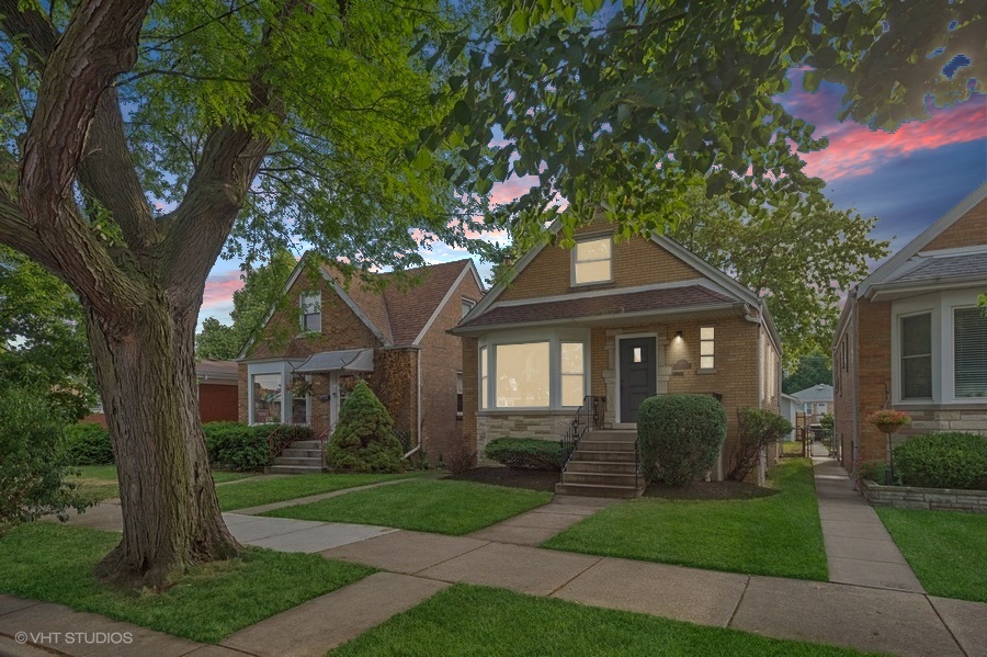 Stylish, Spacious & Fully Renovated in the Heart of Jefferson Park!  This beautifully updated 4-bed, 2.1-bath home blends timeless charm with modern comfort. From the moment you step inside, you'll notice the warm white oak-stained hardwood floors and natural light pouring in through energy-efficient vinyl windows. The open-concept main level features a generous living room, two bedrooms, and a full bath-ideal for flexible living or guest space.    The showstopper kitchen was fully gutted and reimagined with quartz countertops, white shaker cabinetry, stainless steel appliances, and a classic subway tile backsplash. A cozy, finished porch just off the kitchen offers the perfect bonus space for a home office, reading nook, or playroom.    Upstairs, you'll find two more bedrooms and a convenient half bath. The fully finished basement-complete with exterior access-boasts a spacious family room, custom wet bar, a sleek full bath with walk-in shower, dedicated laundry area, and ample storage.    Major updates include: new HVAC & A/C condenser, new 2-car garage, copper plumbing, upgraded 100-amp electrical panel, spray foam insulation, and all-new mechanicals-ensuring peace of mind for years to come.    All this in a fantastic Jefferson Park location near parks, top-rated schools, shopping, Metra & Blue Line, and easy expressway access. Truly a turn-key gem you don't want to miss!