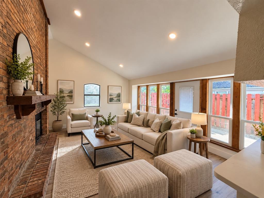 This 2-bedroom townhouse is prepped and ready for new owners with fresh paint, luxury vinyl plank flooring, quartz countertops, updated lighting, and more! High ceilings and an impressive brick fireplace create a warm, inviting living space. The kitchen opens to the living room and features stainless steel appliances including a built-in microwave, smooth-top range and dishwasher, plus a new sink, faucet, lighting and convenient breakfast bar. Upgraded windows add energy efficiency and natural light.Both bedrooms feature vaulted ceilings for an open, airy feel. The upstairs bedroom lives like a second primary suite with its own ensuite bath and walk-in closet.Located adjacent to Generations Park at Boys Ranch in Bedford, offering an incredible recreation facility within walking distance. A dedicated parking space is conveniently located near the entrance. HOA amenities include a community pool, clubhouse, water, trash and recycling, community spaces, and exterior maintenance of the units. Refrigerator and all-in-one washer-dryer are available for purchase with the property.