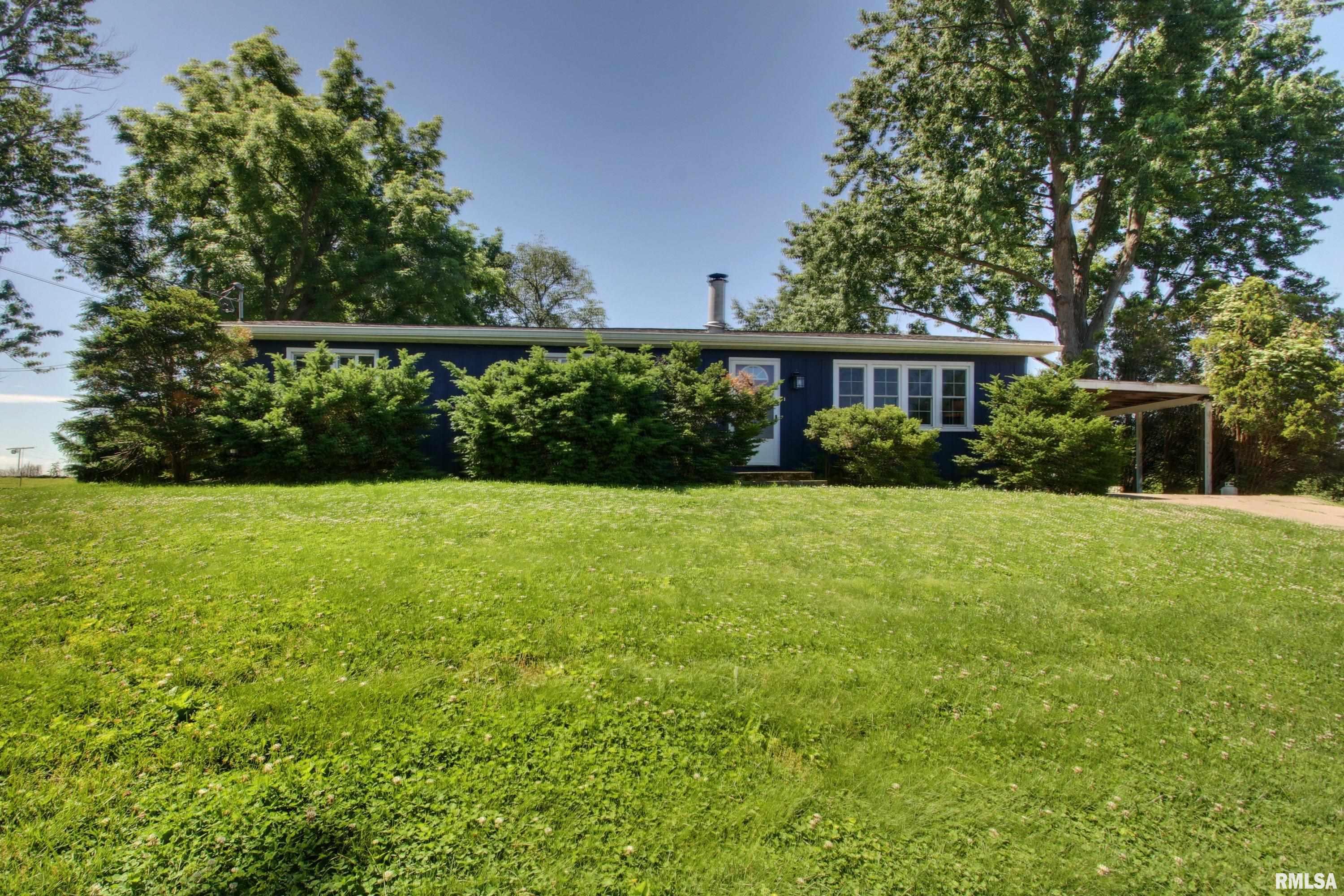 Tucked just outside city limits on a sprawling 21,753 sq ft lot (nearly a half an acre), this move-in-ready 3 bedroom 2 bath ranch blends comfort, style, and room to breathe. With 1,346 square feet on the main level every inch is thoughtfully designed and beautifully maintained.  Step inside to gleaming hardwood floors and a warm, neutral palette that makes the home feel bright, fresh, and ready for your personal touch. The living room invites you to unwind by the cozy wood burning fireplace that is the perfect centerpiece for chilly evenings. The updated, stylish kitchen is a true showstopper, outfitted with high end stainless steel appliances and finishes that elevate everyday cooking and entertaining alike.   Retreat to your private master suite which is a quiet escape all your own. Energy efficient double pane vinyl replacement windows keep things comfortable year round, while the attached two car carport adds everyday convenience. Out back, a spacious deck overlooks an open field; your front row seat to peaceful country views, morning coffee, and summer sunsets. A large storage shed offers all the room you need for tools, toys, and projects, and the generous lot gives you space to garden, play, or simply enjoy the elbow room that in town living rarely affords.  All this in a sought after south end location, close to everything Quincy has to offer while still feeling like a private getaway! Schedule your showing today!