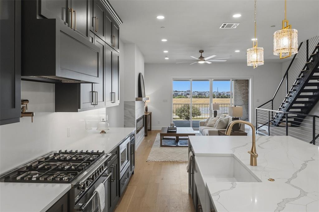 This beautifully designed contemporary residence offers an exceptional combination of generous living spaces, elevated finishes and expansive views of the Trinity River and downtown Fort Worth skyline. The second floor was designed for entertaining, anchored by a gorgeous kitchen with quartzite countertops, built-in refrigerator and a dedicated built-in bar area. An oversized dining room and spacious living room with electric fireplace create an impressive yet comfortable gathering space, while walls of windows draw your eye toward the covered patio and sweeping downtown views beyond.The third-floor primary suite provides a private retreat above it all, complete with a beautifully appointed primary bath and an elevated vantage point overlooking the surrounding riverfront setting and city skyline. 2 additional bedrooms lie down the hall, past the separate utility room, with extra cabinetry.With its larger floor plan, substantial entertaining spaces, high-end finishes and incredible connection to the outdoors, this residence takes full advantage of its coveted location along the Trinity River, minutes from downtown.