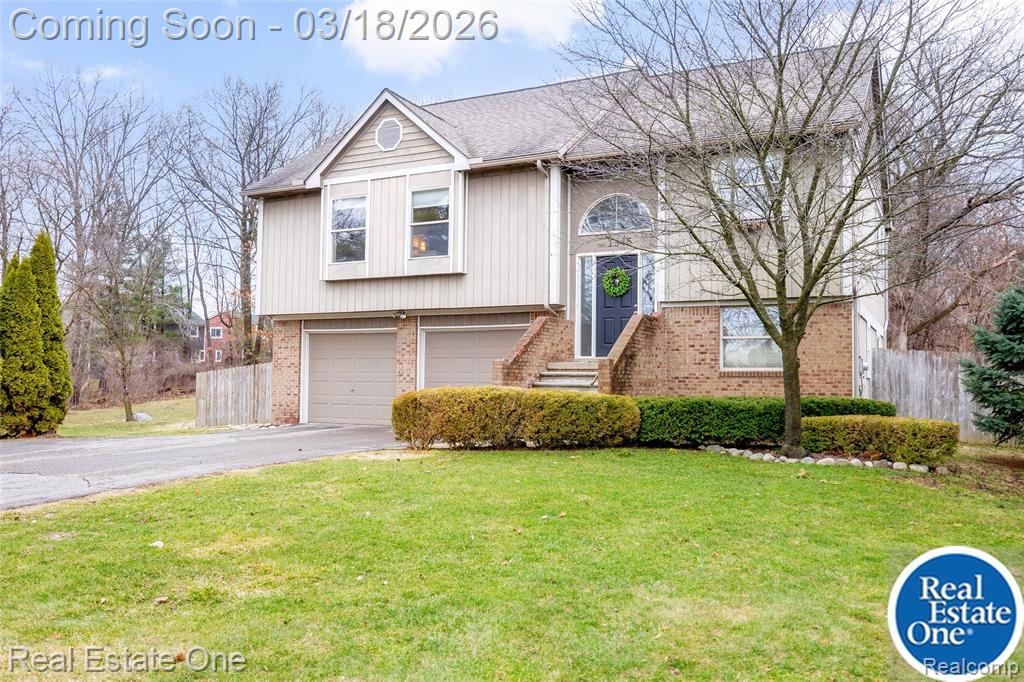 Welcome to this beautiful home just minutes from downtown Milford, offering the perfect blend of privacy, space, and convenience. Nestled on just under 2/3 acre with scenic wooded views, this spacious property provides a peaceful setting while remaining close to shopping, dining, and major expressways.This charming home features approximately 1,937 square feet of living space, with 3 bedrooms and 2 full bathrooms. The open and inviting main living area is flooded with natural light and offers plenty of room for relaxing or entertaining guests. The finished walkout lower level provides additional living space that can be used as a home office, playroom, or recreation area, along with a full bathroom. Step outside to enjoy the large backyard, complete with a deck off the great room—perfect for summer gatherings, outdoor dining, or simply enjoying the peaceful surroundings. Additional highlights include: Oversized 2 car attached garage with built-in storage. Large fenced in yard. Bonfire area in the wooded backdrop. Generous parking and setback from the road for added privacy. Conveniently located near Kensington Metroopark, bike/walk trails, GM Proving Grounds and with quick access to Interstate 96, this home offers an easy commute while still enjoying the charm of a small-town community. New septic tank and field summer 2025, most of interior professionally painted fall 2025, water heater 2024Showings start 3/19/26Open House 3/22/26 1-3pm