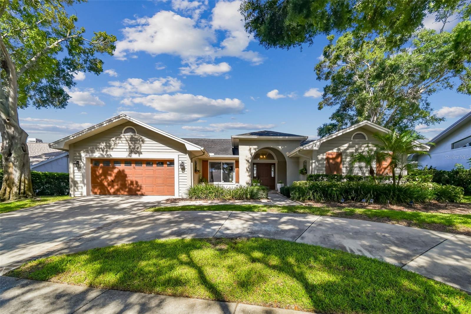 This lovely pool home has been tastefully updated and is ready for move-in.  Not in a flood zone, and situated in one of the hottest Palm Harbor neighborhoods, Waterford Crossing,  popular due to the excellent location.  Located just up the road from the Dunedin Causeway, Honeymoon Island beaches, the Pinellas Trail, Downtowns Dunedin and Palm Harbor, popular local restaurants, shopping and more.  Hop on your bike and join the fun!  Step into this beauty and discover a light and pleasant environment highlighted by popular updates, a flowing open floor plan, vaulted ceilings, neutral colors and multiple sets of sliding doors that create that special blend of indoor and outdoor living.  Sellers installed roof solar panels and enjoy $35.00 electric bills.  The updated kitchen is anchored by a massive custom island with plenty of seating, tons of storage and granite tops.  Positioned with the open great room on one side and sliding doors open to the covered lanai and pool, the kitchen is set up for convenient living and entertaining.  The kitchen also has lovely custom backsplash tile and a walk-in pantry.  The primary suite has sliding doors to the covered lanai, a vaulted ceiling, views of the pool AND an updated ensuite bathroom with separate tub and tile shower, linen closet, dual sinks and 2 built-in custom closets.  While I'm at it, bedrooms 2 and 3 are nicely sized and EACH has a walk-in closet.  The formal dining room is conveniently located to the kitchen and big enough for a large table for entertaining.  It also has another set of sliding doors out to the covered lanai.  The outdoor living space in this home is what it's all about.  The spacious covered living space has room for outdoor family room and dining spaces.  The screened pool has tall, volume trusses that encompass the entire pool decking area and covered lanai area.  There's lots of decking space (all finished with pavers) around the pool and there is no feeling of the pool being jammed up next to the house.  The sellers say they enjoy the best sunsets ever from their lanai.  Does this sound like the kind of lifestyle you're looking for?  It's special. Living the dream here!  Why don't you?