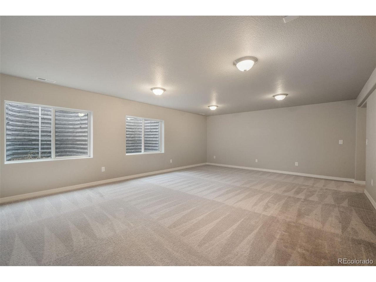 Nestled in Forest Lakes with a peaceful lake just beyond the backyard and surrounded by mountain views, this 2019 ranch offers thoughtful main level living in one of Monument's most scenic west-side communities. Forest Lakes is loved for its foothills setting, Bristlecone Lake and Pinon Lake, trails, parks, and access to open space, giving the neighborhood a tucked-away Colorado feel while still keeping everyday conveniences within easy reach. The open floor plan features 9'+ ceilings, central AC, a bright great room with walk-out access, and a kitchen designed for everyday ease with stone countertops, center island, pantry, gas range, stainless steel appliances, and an adjoining dining area. The main level includes 2 bedrooms, including the primary suite with a walk-in closet and private 5 piece bathroom with double vanity, soaking tub, and freestanding shower, plus an additional full bathroom and convenient main level laundry. The finished basement expands the home with a spacious living room, 2 additional bedrooms, both with walk-in closets, and a full bathroom, offering flexible space for guests, work, hobbies, or movie nights. Outside, enjoy a covered front porch, back patio, fully landscaped corner lot, fenced backyard and automatic sprinkler system. Located in Lewis-Palmer School District 38 and about 15 minutes from the U.S. Air Force Academy with easy access to I-25, Monument, Northgate, north Colorado Springs, shopping, trails, and Forest Lakes amenities, this home combines turnkey living, desirable ranch layout, and a beautiful community setting.