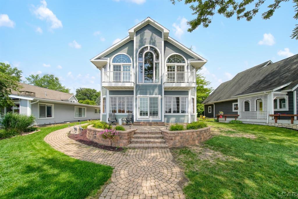 Located on the highly sought-after Cherry Point, this custom-built, one-owner home offers 50 feet of pristine frontage on all-sports Devils Lake!  With 4 spacious bedrooms and 3 full bathrooms, this thoughtfully designed home features two living rooms, perfect for entertaining or hosting extended family and friends. The gas fireplace adds warmth and charm to the second-level living area, while the second-level laundry adds everyday convenience.  Upstairs, the primary suite includes a private balcony overlooking the water ideal for quiet mornings or sunset views. The attached 2.5-car garage provides ample space for vehicles, lake gear, and storage.  Whether you're looking for year-round lake living or a summer getaway, this home combines quality construction, generous space, and one of the best locations Devils Lake has to offer.