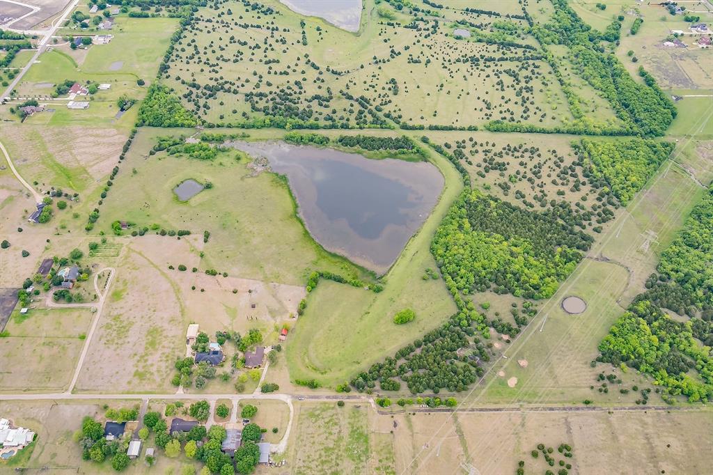 Rare opportunity to own a private, Ag-exempt estate just minutes from Rockwall's best amenities. This 92+ acre property boasts ownership of Rocki Dell Lane and over 750' of Rochelle Road, and offers the perfect blend of seclusion and convenience — all zoned to sought-after Rockwall ISD. The property has a custom-built home, nearly 4,000 square feet with 4 bedrooms and 3.5 bathrooms, constructed in 1980. The house needs some updating, but the potential is there — bring your vision and make it your own. Enjoy access to an 8.5-acre lake, offering excellent fishing, recreation, or simply peaceful views right outside your door. With no HOA and no restrictions against building, this property is wide open for its next chapter — whether that's a private family estate, a hunting and recreation getaway, or a development opportunity. The Ag exemption keeps taxes low while you decide your next move, and the current cattle lease can be continued for your convenience.  Property is also a part of McClendon-Chisholm ETJ, which gives developers a unique chance to benefit from city funds and tax incentives if desired. Bonus opportunity: If you're looking for more than 92 acres, there is a neighbor offering 22 acres off-market as well. Contact the listing agent for more details — this is a rare chance to assemble a large, contiguous tract in a high-growth corridor. Location perks: 13 minutes to Lake Ray Hubbard 7 minutes to HEB Rockwall 8 minutes to Costco 12 minutes to Rockwall High School 12 minutes to Texas Health Hospital Sellers are motivated. Call or text listing agent for a private showing or more information on the full 92-acre package!