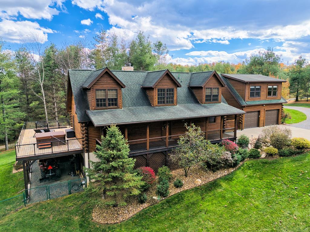 LIVE like you're on VACATION every day in this stunning 4-bedroom, 4-bath log home located just minutes from Town of Floyd! This meticulously built home features solid HW floors throughout w/ solid wood interior doors. A dramatic wall of windows fills the living room w/ natural light, while 12,000 KW off-grid solar system efficiently powers most of home. Solar is located in the new, 2nd detached garage for additional space. The kitchen offers granite countertops, a walk-in pantry w/ breakfast bar. The dining area opens to spacious deck, also accessible from the living room& main-level primary suite w/ luxurious updated primary bathroom! The bonus room over garage includes full bath & separate entrance, perfect for a4th bedroom, guest suite, home office or Airbnb rental. The finished walk-out basement features family room w/ wood stove, additional flex room &beautifully tiled bathroom w/ shower & vessel sink. Peaceful surroundings & a fantastic property!!!