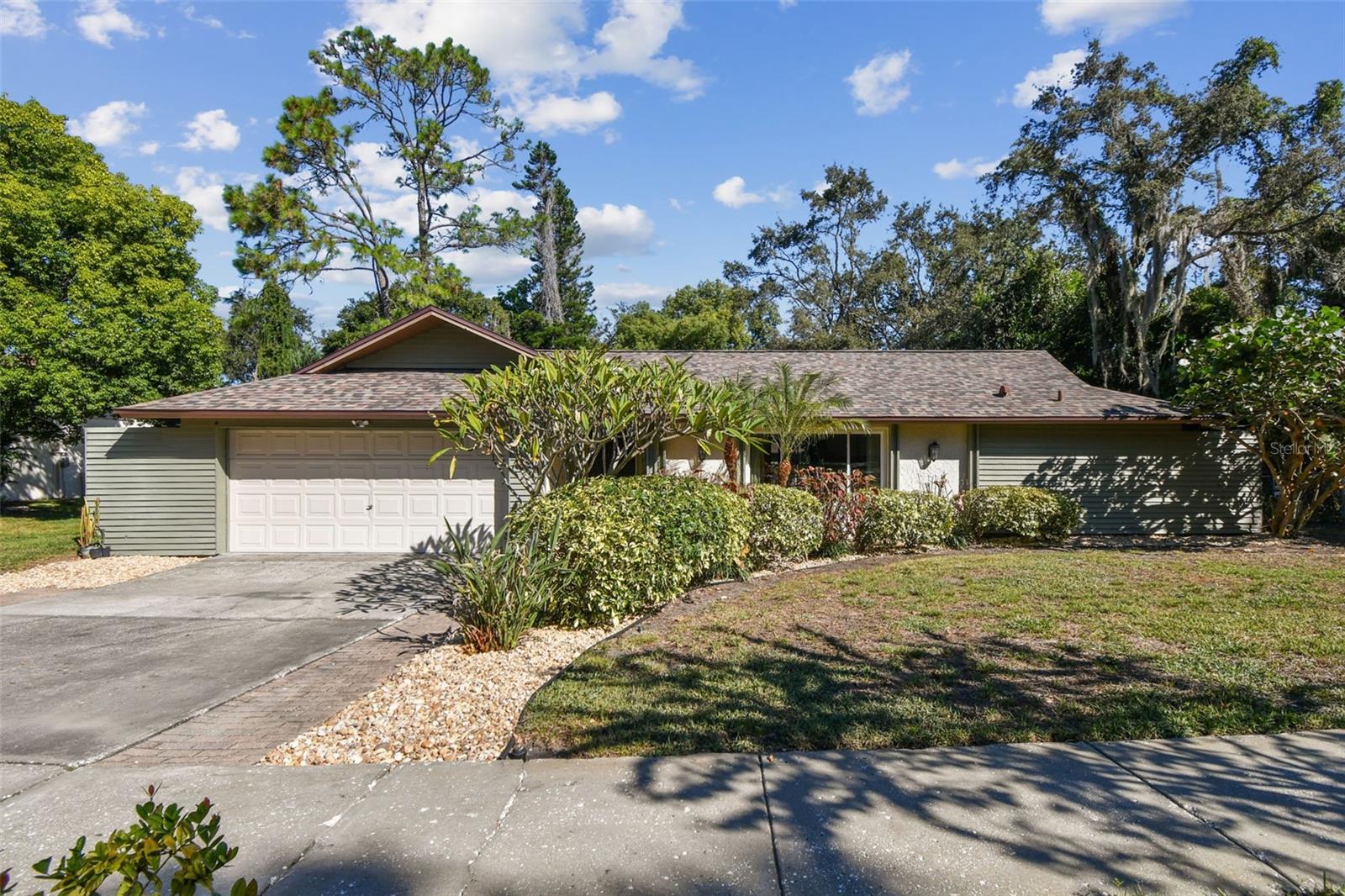 One or more photo(s) has been virtually staged. Welcome to this beautifully renovated 4-bedroom, 2-bathroom home offering nearly 2,000 square feet of comfortable living space in the highly desirable community of Westlake Village in Palm Harbor. As you step through the front door into the foyer, you’re greeted by a bright and inviting living room to your right, which flows seamlessly into the formal dining room overlooking the lush backyard. This home features a thoughtful split floor plan, with a spacious master suite complete with a walk-in closet, a private en suite bathroom and its own set of sliders leading to the side of the house. Across the home, past the updated chef's kitchen you will find three additional bedrooms, a full bathroom, and an indoor laundry room with a utility sink. The property has been tastefully renovated throughout, showcasing luxury vinyl plank flooring,  fresh interior paint and trim, and a stunning chef’s kitchen with stainless steel appliances. A newer roof and hurricane impact windows provide peace of mind for years to come! The oversized, fully fenced backyard offers plenty of space to add a pool and features a spacious screened porch with a beautiful paver patio—perfect for entertaining or relaxing outdoors. Residents of Westlake Village enjoy access to exceptional community amenities including a park, playground, clubhouse, pool, and more. Ideally located only 10 minutes from local beaches like Honeymoon Island, Sunset Beach, and Fred Howard Park, and only 35 minutes to Tampa International Airport! This home blends style, comfort, and convenience in one of Palm Harbors most sought-after neighborhoods!