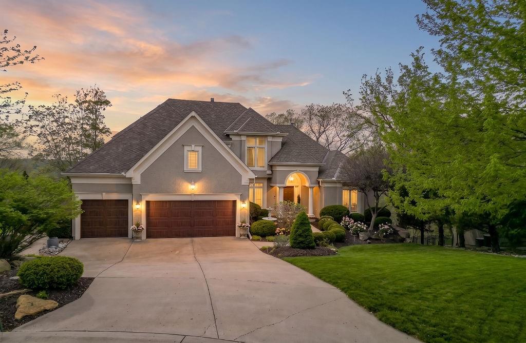 This meticulously maintained 1.5-story home with a finished walk-out basement is perfectly situated at the end of a quiet cul-de-sac. Set on a spectacular wooded lot backing to a scenic valley and greenbelt, the property offers exceptional privacy and serene views, with frequent visits from local wildlife.Main level features an open formal dining room perfect for entertaining large groups, a living room with a wall of windows, hearth room with built-ins and a see-through brick fireplace to the living room, and an updated kitchen (2024) with white quartz and three pantries (one walk-in). The main-floor primary suite offers a bay window, boxed vaulted ceiling with interior lighting, a spa-like bath with separate tub and shower, see-through fireplace to the bedroom, and a huge walk-in closet. Laundry with desk/folding counter off the 3-car garage. Screened deck overlooks private, tree-filled backyard.Upstairs: three bedrooms — two share a Jack-and-Jill bath, one with a private ensuite — plus built-in bookcases in the hall and guest bedroom and easy attic access that could be finished as a loft. Finished walk-out basement includes large game area with wet bar, 5th bedroom, 4th full bath, separate TV room, and patio.Additional highlights: immaculate condition, hardwoods on main level, plantation shutters, central vac, sprinkler system, wired for surround sound on main floor, natural stone landscaping and retaining walls, stamped concrete walkways, exterior paint 2022, dual HVAC units.Enjoy resort-style living in Cedar Creek — one of Kansas City’s finest neighborhoods with access to a 65-acre fishing lake, 3 community pools, lighted tennis & pickleball courts, clubhouse, indoor gym, and miles of walking trails.