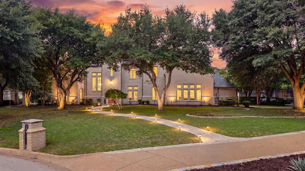 This exceptional 9,275-square-foot custom estate spans three levels on 2.56 private acres. A dramatic cast-iron circular staircase, crowned by a crystal chandelier, anchors the home, while a private elevator provides seamless access to every floor. Custom woodwork defines doors, cabinetry, walls, and ceilings, and every window has been newly replaced, bathing the interiors in natural light. The main level flows with elegance, opening to a spacious living room defined by floor-to-ceiling windows, a coffered ceiling, and formal wet bar. Beyond lies an elegant dining room, family room, and chef’s kitchen appointed in decorative granite, imported marble floors, and radiant heated flooring that continues through two bedrooms, the great room, and billiards room. Multiple offices and custom built-ins complete the level; the oversized garage accommodates five vehicles with two car lifts. Designed for entertaining and collecting, the home features a top-to-bottom custom billiards room with coffered ceiling, matching furniture and lighting, plus a climate-controlled 3,500-bottle wine cellar with dual dedicated air-conditioning units and two backup systems. An adjacent lounge to enjoy the collection completes the experience. Four bedrooms include three master suites - two with private entries - while the primary suite features a spacious sitting area and a bathroom wrapped in imported Italian marble. The third level is dedicated to a private gym. Outdoors, a large swimming pool, expansive patio, and newly refinished tennis court deliver a resort-like retreat framed by the privacy and natural beauty of the Trinity River. A rare offering of scale, craftsmanship, and refined livability in Benbrook.