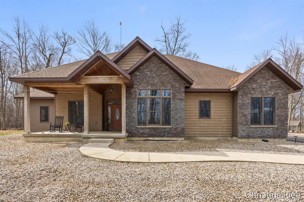 Custom-built home showcasing quality craftsmanship, set on nearly 15 wooded acres just minutes from town. Soaring ceilings and an open living area center around a fireplace, flowing into a spacious kitchen designed with quality finishes, featuring granite countertops, a large island, and a built-in beverage station with wine fridge. Formal dining features a large window that fills the space with natural light. The main level continues with 3 bedrooms, including a private primary suite with a large walk-in closet and spa-like bath, plus convenient main floor laundry, an additional full bath, and a half bath near the garage. Indoor swim spa with direct access from the primary bedroom and living room, creating a private, year-round escape for relaxation and wellness. The lower level offers a generous open layout, 2 non-conforming rooms, and a spacious storage/mechanical area. 8x22 hidden bunker with interior access for storage or shelter!Enjoy the peaceful wooded setting from the country porch. The property includes a 40x40 pole barn with heated floors (ready to connect) and a 3-stall attached garage. The basement floor also has in floor heating that just needs to be connected.  Schedule your tour today!