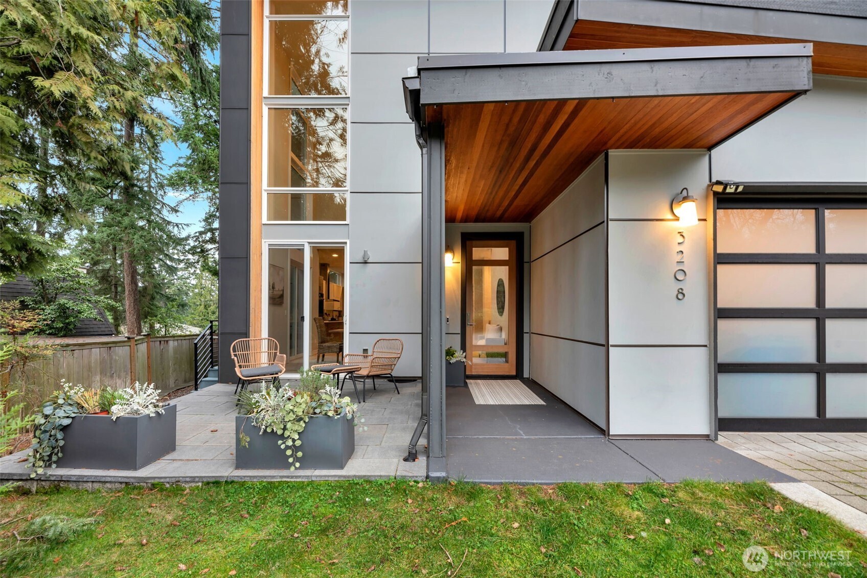 Modern design meets Pacific Northwest living in this light-filled Mercer Island home. A dramatic entry with soaring ceilings and walls of windows sets the stage for open, connected living. At the heart of the home, the chef’s kitchen boasts a 16-foot island, double ovens, and sleek cabinetry—perfect for entertaining or everyday life. A main-level flex room functions as an office or bedroom, with no-stair access. The primary suite offers dual closets, a spa bath, and private deck. The lower level provides guest quarters, family room, or workout space, while the rooftop deck captures serene lake views. The low maintenance yard has a true PNW vibe.  This home balances retreat and convenience—close to Town Center, and Luther Burbank Park.