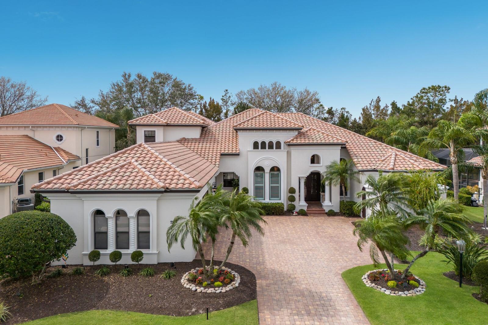 The ultimate tropical oasis setting, this elegantly appointed two-story residence in Lakewood Ranch Country Club exudes a swoon-worthy and private resort feel . The expanded Ballina by John Cannon Homes encompasses 4,487 square feet of generously proportioned living spaces, soaring ceilings, architectural detailing, just PAINTED INSIDE and OUT, and an an expansive outdoor retreat with extensive open and under cover spaces, full summer kitchen with new 2024 grill, heated pool/spa and updated landscaping. 

Live and entertain flawlessly in this two-story just painted and impeccably maintained and updated throughout exuding a classic elegance where there is no shortage of living well.  Beyond the hurricane impact iron entry doors reveals the grandly-sized living room with floor-to-ceiling aquarium windows just off the formal dining area juxtapose a wet bar with NEW thermostat controlled GE Monogram WINE REFRIGERATOR, sink, stone counters and wood cabinetry. 

Meanwhile the epicenter of the home is the family gathering room boasting a gas fireplace and disappearing cornerless sliding glass walls that brings the outdoor living area in seamlessly incorporating the breakfast area and gourmand’s well-appointed kitchen with All NEW 2024 GE MONOGRAM APPLIANCES, wood cabinetry, ample granite and quartz counters, and an oversized walk-in pantry. The residence also features a designated office on the main level that offers built-in bookshelves, soaring ceilings and wood flooring. 

Relax and unwind in the elegant owner’s retreat positioned on its own private wing on the main level with direct lanai access, elevated sitting area, two customized walk-in closets, and a luxuriously appointed spa-like bath with separate vanity stations, dual entry shower, and a separate soaking tub.  Guests will appreciate two generous suites on the main level, each with access to their own full bath and walk-in closets. The home’s fourth guest suite and fourth full bath resides on the upper level, as does the expansive bonus room with screened terrace with all new aluminum railings and screens.  This bonus room offers flexible living options as a theater, game room, secondary office or potential 5th guest suite. 

Positioned within the luxury enclave of Legends Walk, there are numerous appointments that highlight this magnificent Country Club residence, some of which include newly installed AC units in 2021, impact double iron front doors in 2022, hot water heater in 2021, new pool heater in 2023, Sonos sound system inside and outside updated in 2022, landscape lighting updated in 2021, refurbished sprinkler system in 2022, laundry room with ample cabinetry, sink and newer washer/dryer, interior paint completed in 2024, exterior painted in 2024, and a courtyard side-load 3 car garage with Garage Tek storage cabinets, and epoxy flooring in 2024. 

Non-mandatory membership opportunities to become a member of Lakewood Ranch Golf & Country Club are possible, which includes a state-of-the-art Fitness center, Clubhouses, junior Olympic-sized pool, four 18-hole championship golf courses, Tennis, Pickleball and more. Lakewood Ranch is the #1 top-selling master-planned community in the country with shopping, dining, A-rated schools, and, of course, Sarasota’s renowned beaches.