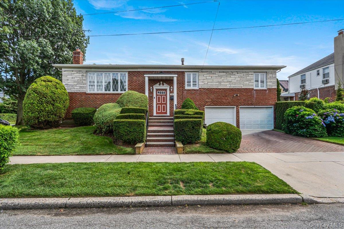 Welcome to this expansive, well-maintained Hi-Ranch home located in the desirable neighborhood of Beechhurst, offering two generous levels of comfortable living space. The main upper level features a spacious living room and dining area with hardwood floors, creating an inviting space for daily living and entertaining. The eat-in kitchen provides seamless access out to the yard. This level features four well-proportioned bedrooms, including a primary bedroom with a private ensuite bathroom, plus an additional full bathroom. The lower level offers exceptional flexibility, highlighted by a warm family room/den featuring a cozy brick fireplace. This level also includes an additional bedroom, a convenient summer kitchen, a full bathroom, laundry, extra storage space, and direct access to the garage and yard. Designed for both relaxation and everyday functionality, this spacious home provides all the room you need in a prime Beechhurst location. Close to Whitestone Shopping Center, restaurants, houses of worship, schools, and playgrounds. Conveniently located near the Q61 bus providing direct service to downtown Flushing, the 7 subway, and LIRR. Additional nearby transportation options include the Q15 and Q76 local buses and the QM32 express service to Midtown Manhattan. Motorists enjoy convenient access to the Cross Island Parkway, the Whitestone Expressway, and the Bronx–Whitestone Bridge.